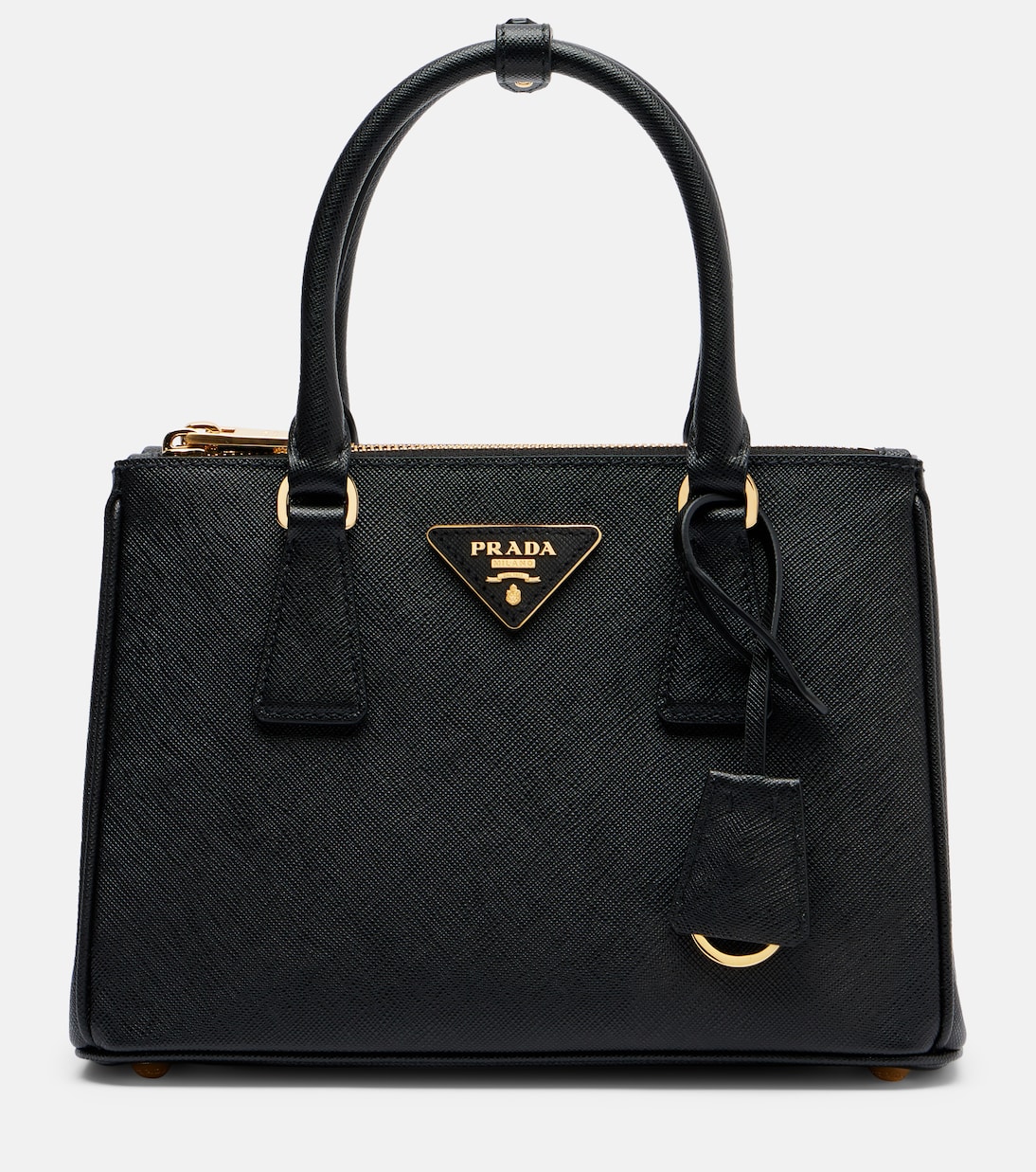 Detail of the gold triangle logo against the waxed Saffiano grain