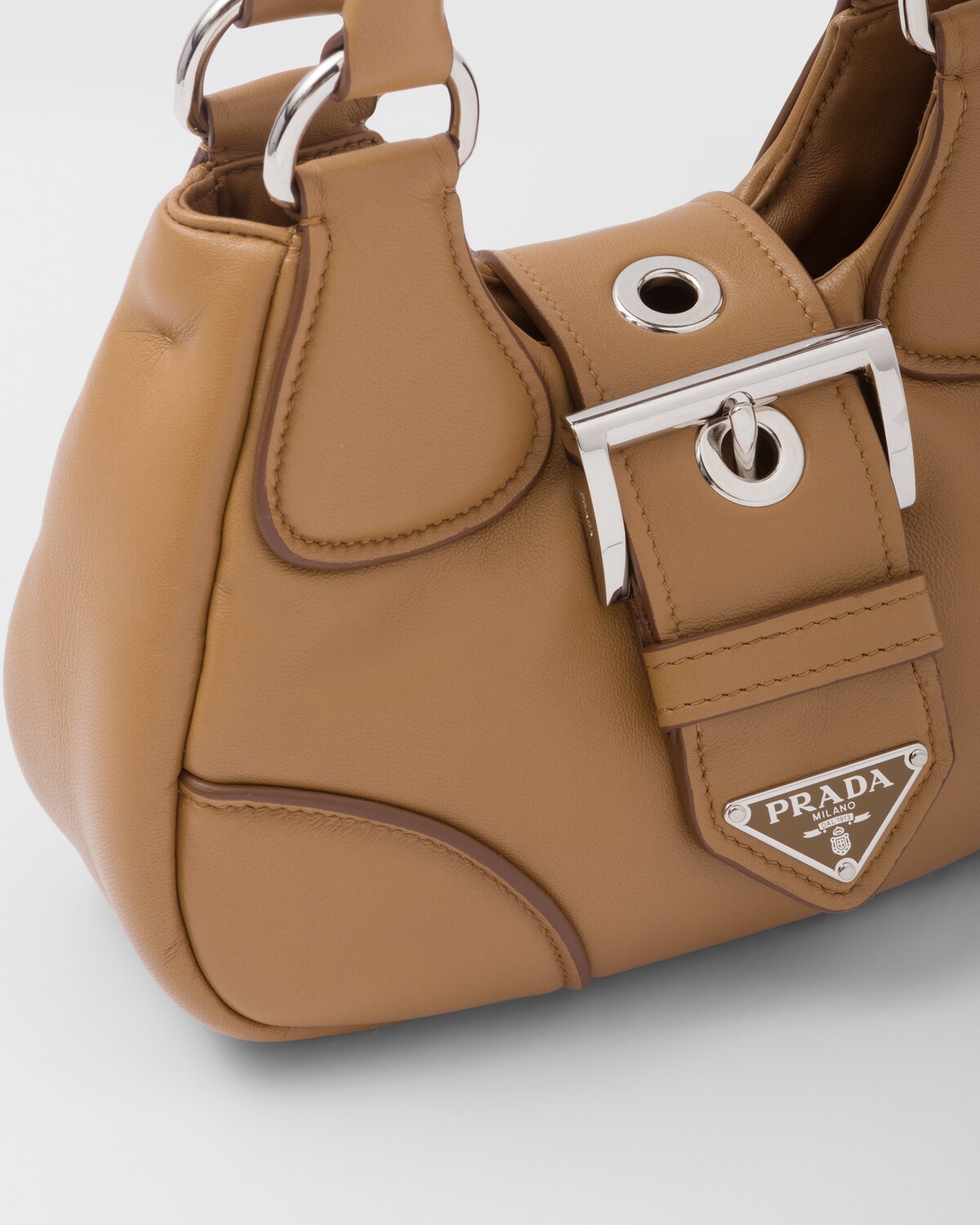 Detail of the padded leather, belted closure and triangle logo