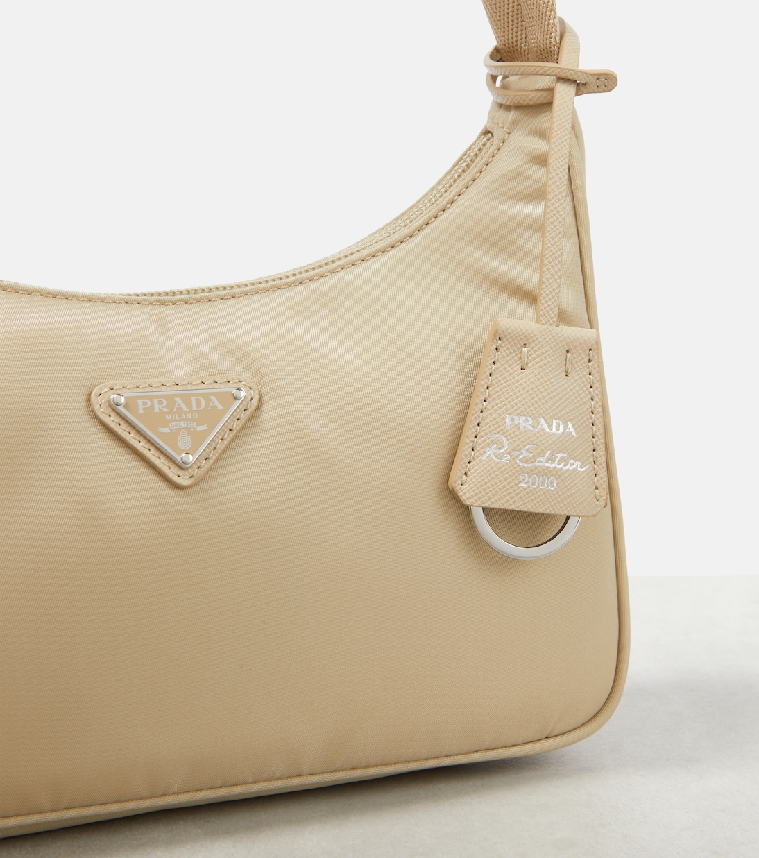 Detail of the triangle logo plaque and Re Edition 2000 leather tag