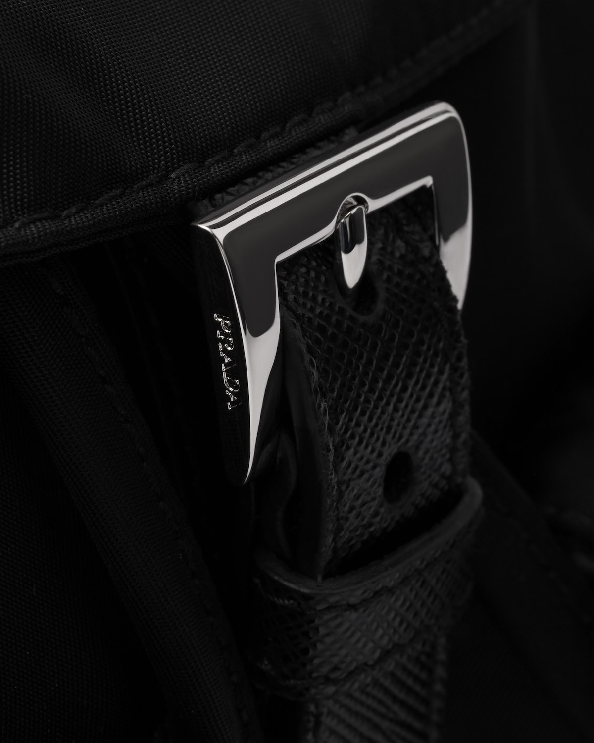 Detail of the buckle hardware and Saffiano-trimmed strap
