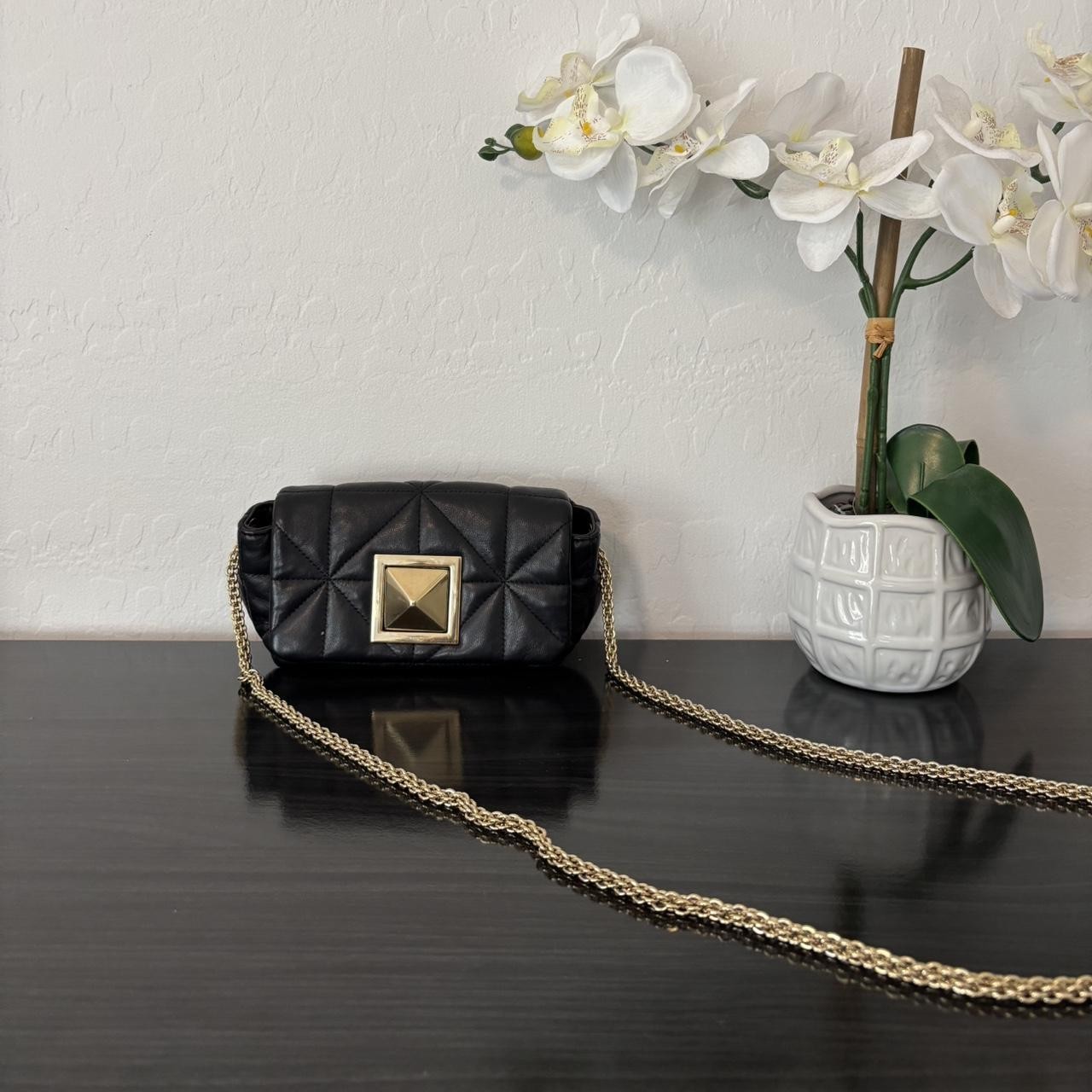 Small black Le Copain styled as a crossbody