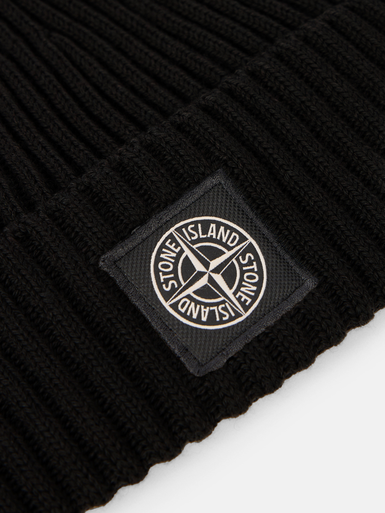 Detail — the buttoned compass badge up close