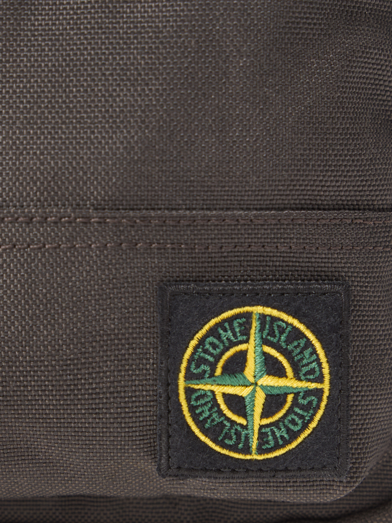 Detail — the compass badge on the front