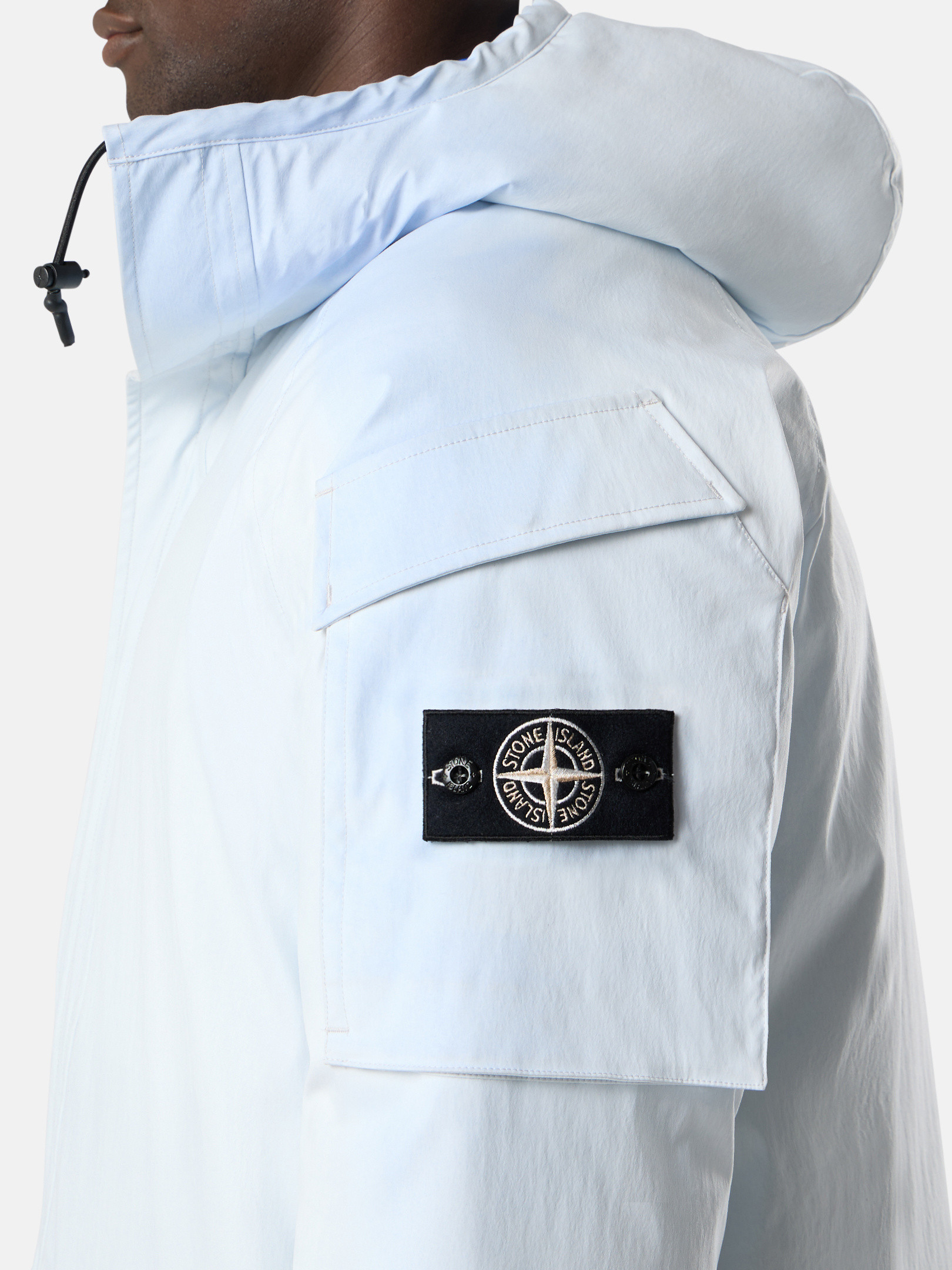 Detail — the compass badge and arm pocket