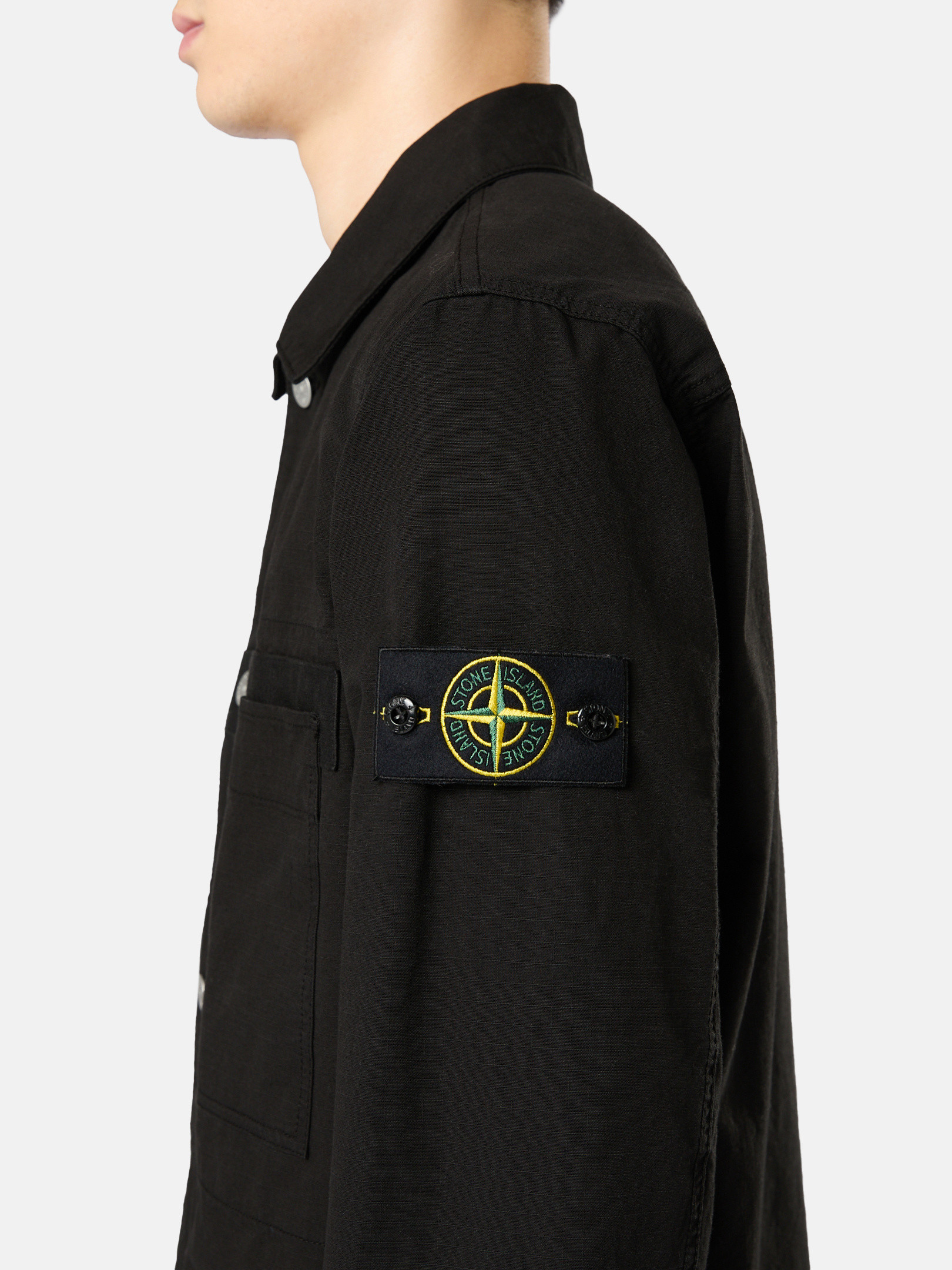 Detail — the compass badge on the left arm