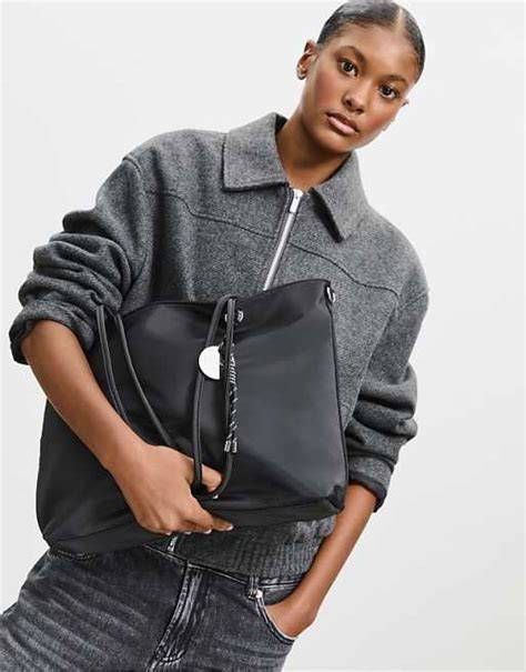 Stradivarius Fabric shopper bag with charm in black | ASOS