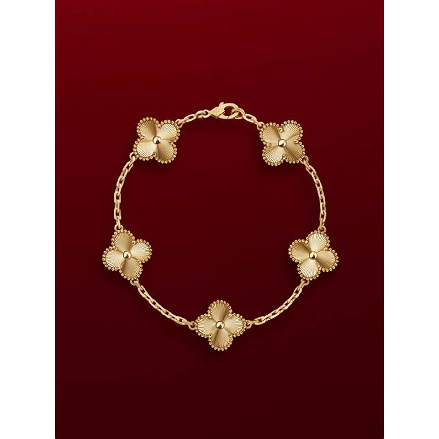 yellow-gold bracelet against a dark ground