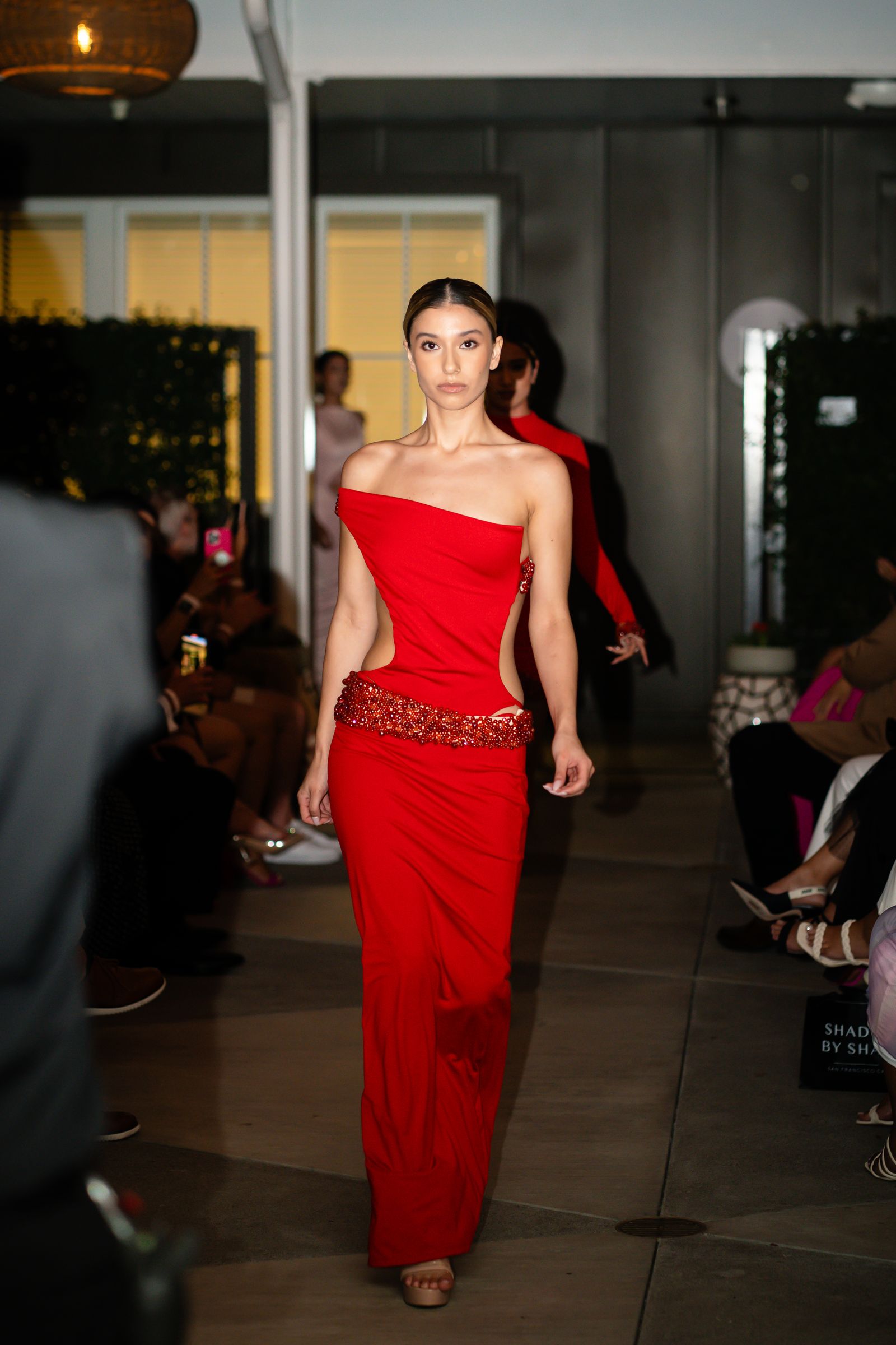 Model in a red gown on the runway