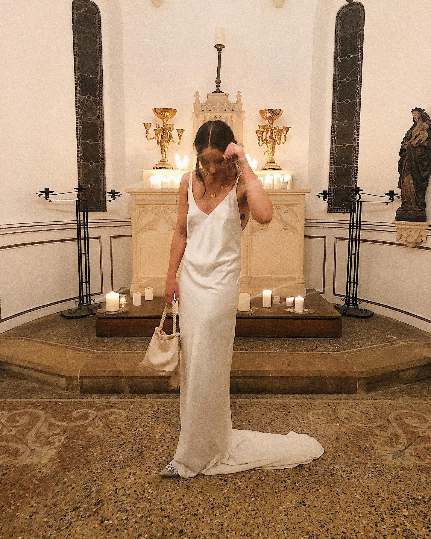 Emily J. Dawes wearing a white slip dress for a formal celebration