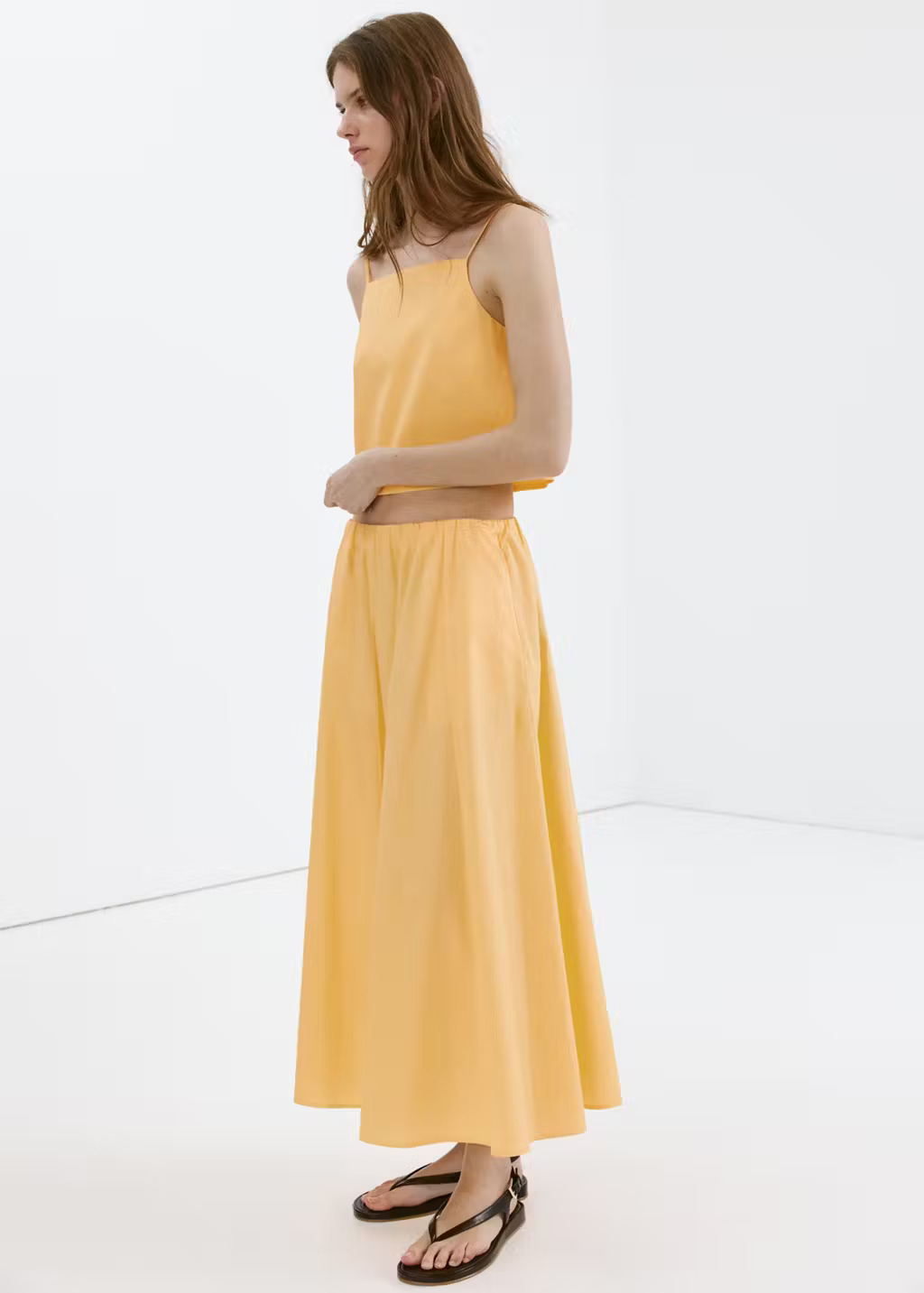 Mango pastel-yellow flared cotton midi skirt worn with a matching camisole