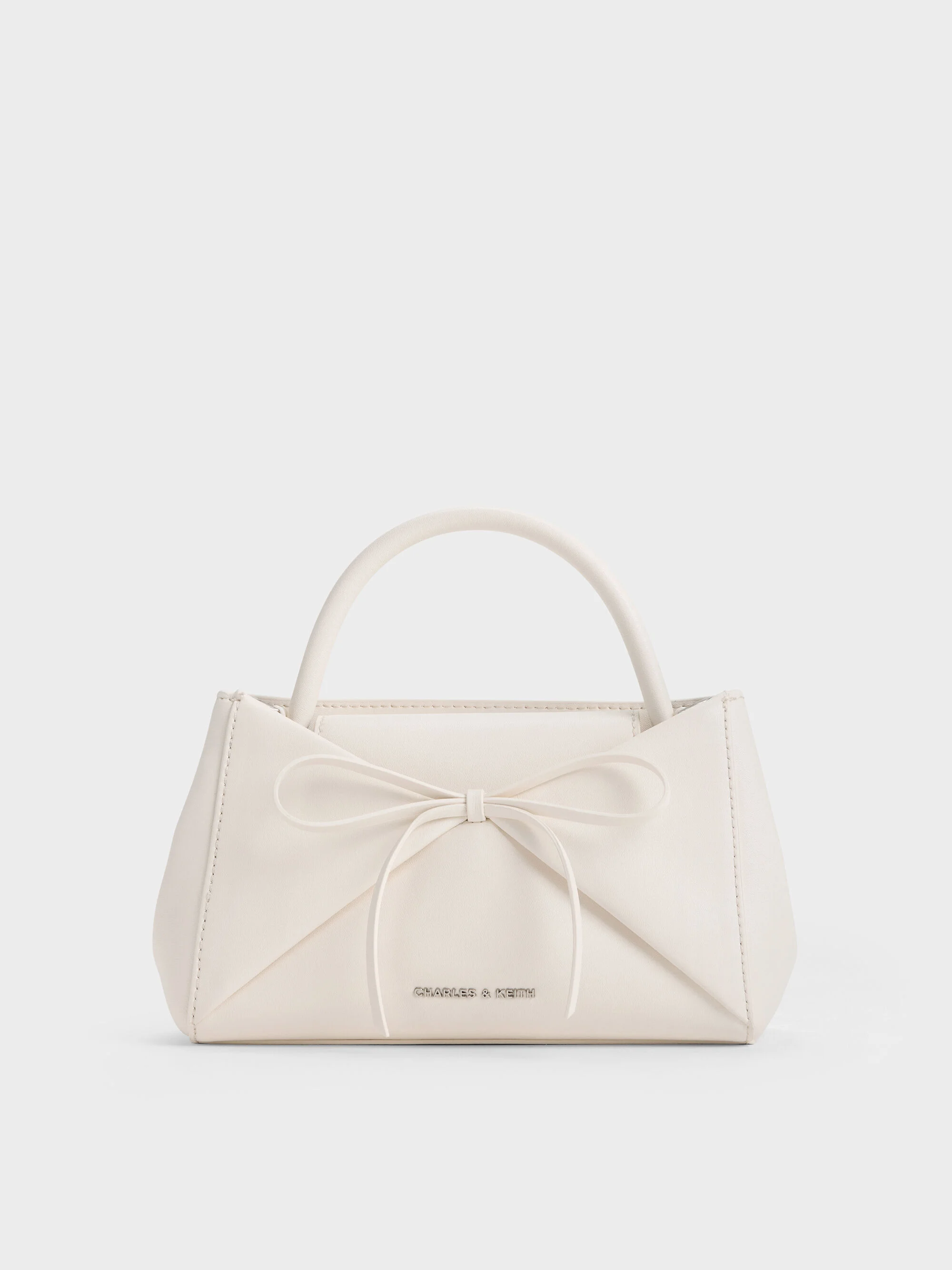 Charles and Keith cream Hazel bow panelled top handle bag