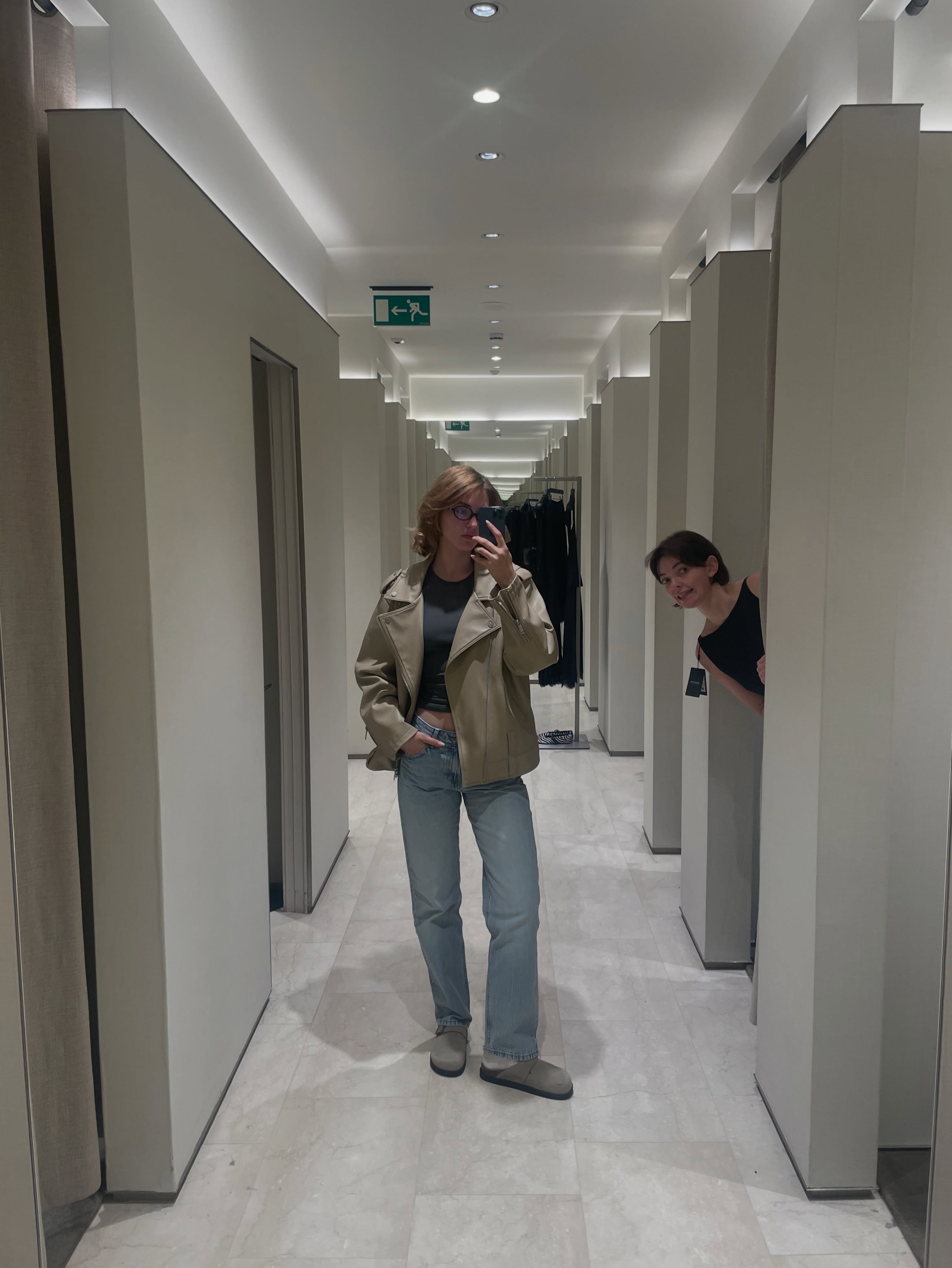 Anna Bobroff taking a full-length fitting-room mirror photo during a shopping day