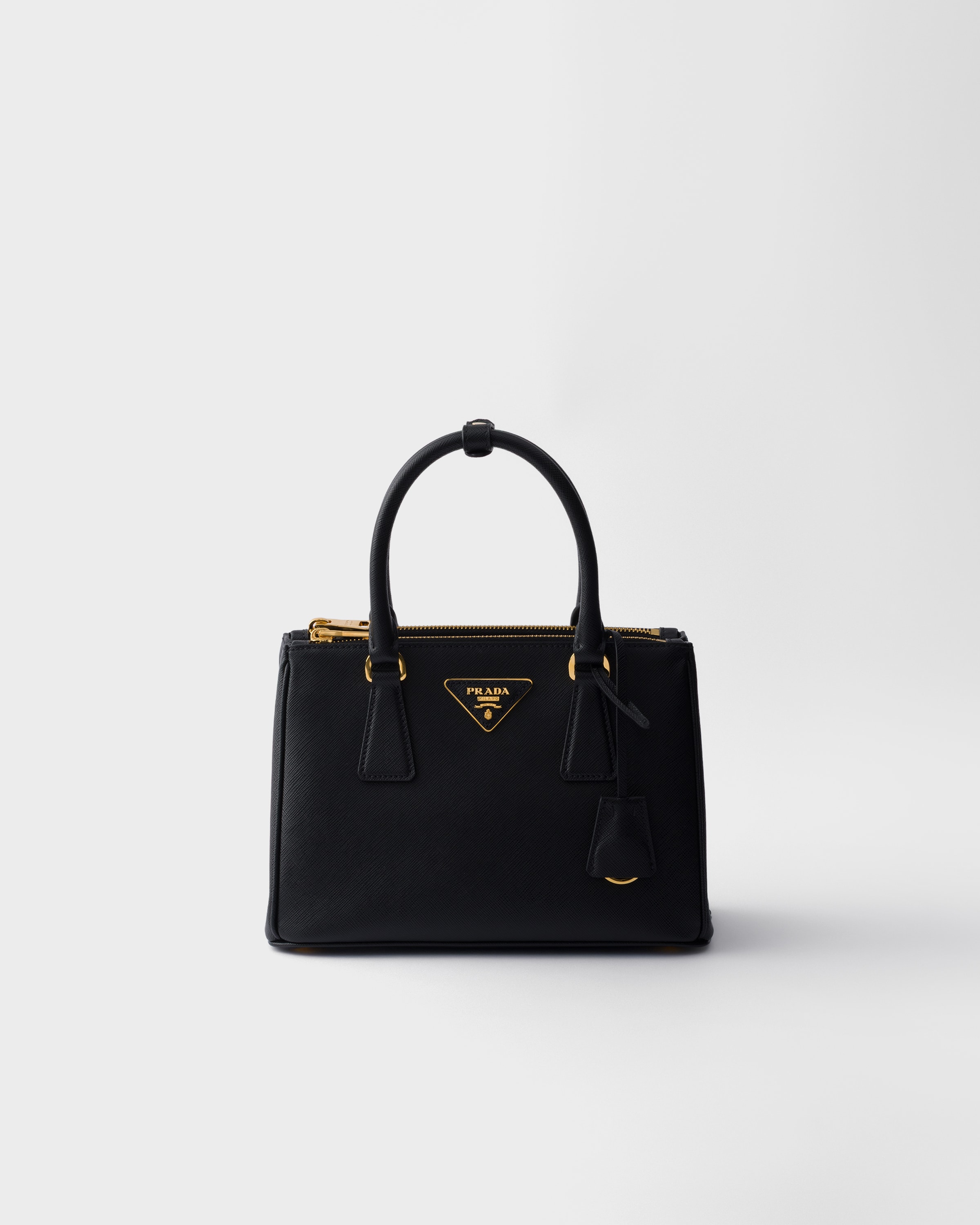 Black Prada Galleria small Saffiano leather bag front view with leather handles and zipper top.