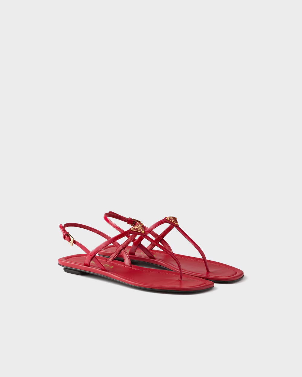 Red Prada patent leather thong sandals with triangle-logo hardware