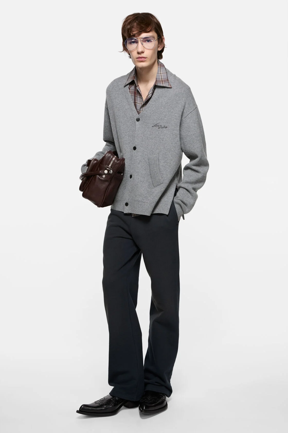 Model wearing a relaxed grey Acne Studios wool V-neck cardigan