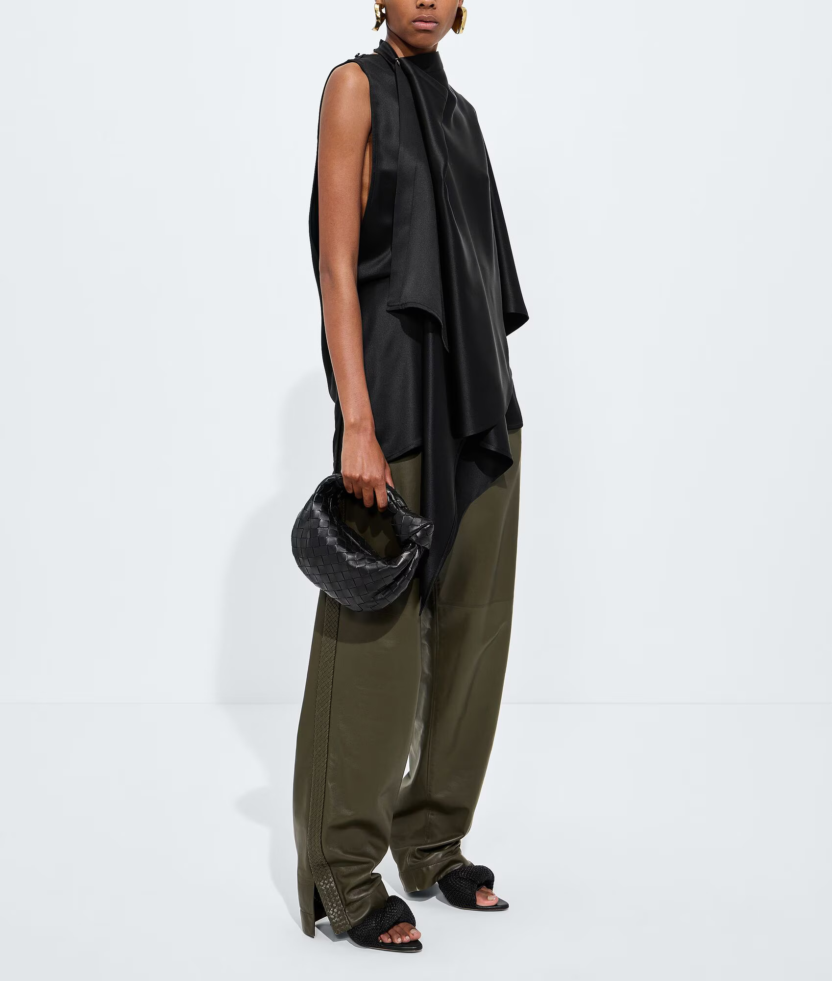 Bottega Veneta Mini Jodie black on model with hand-carry proportion