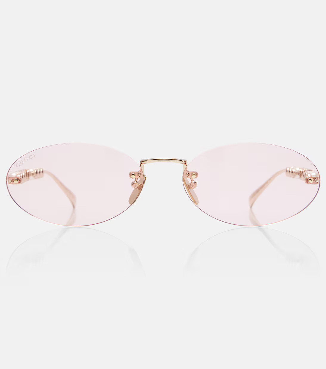 Gucci oval sunglasses with pale pink lenses and gold-tone bridge