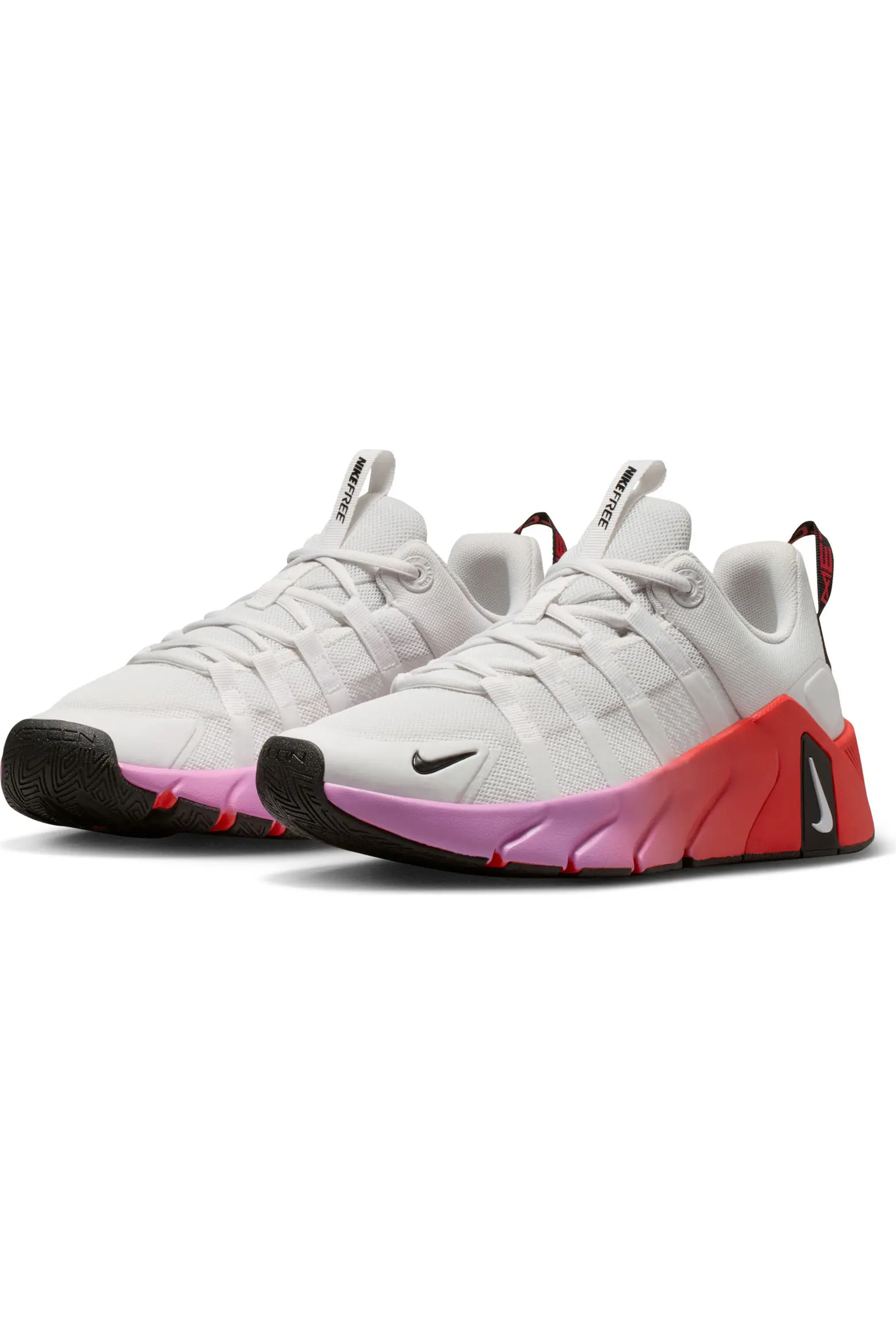 Pair of white Nike Free Metcon 7 training shoes with pink and red soles