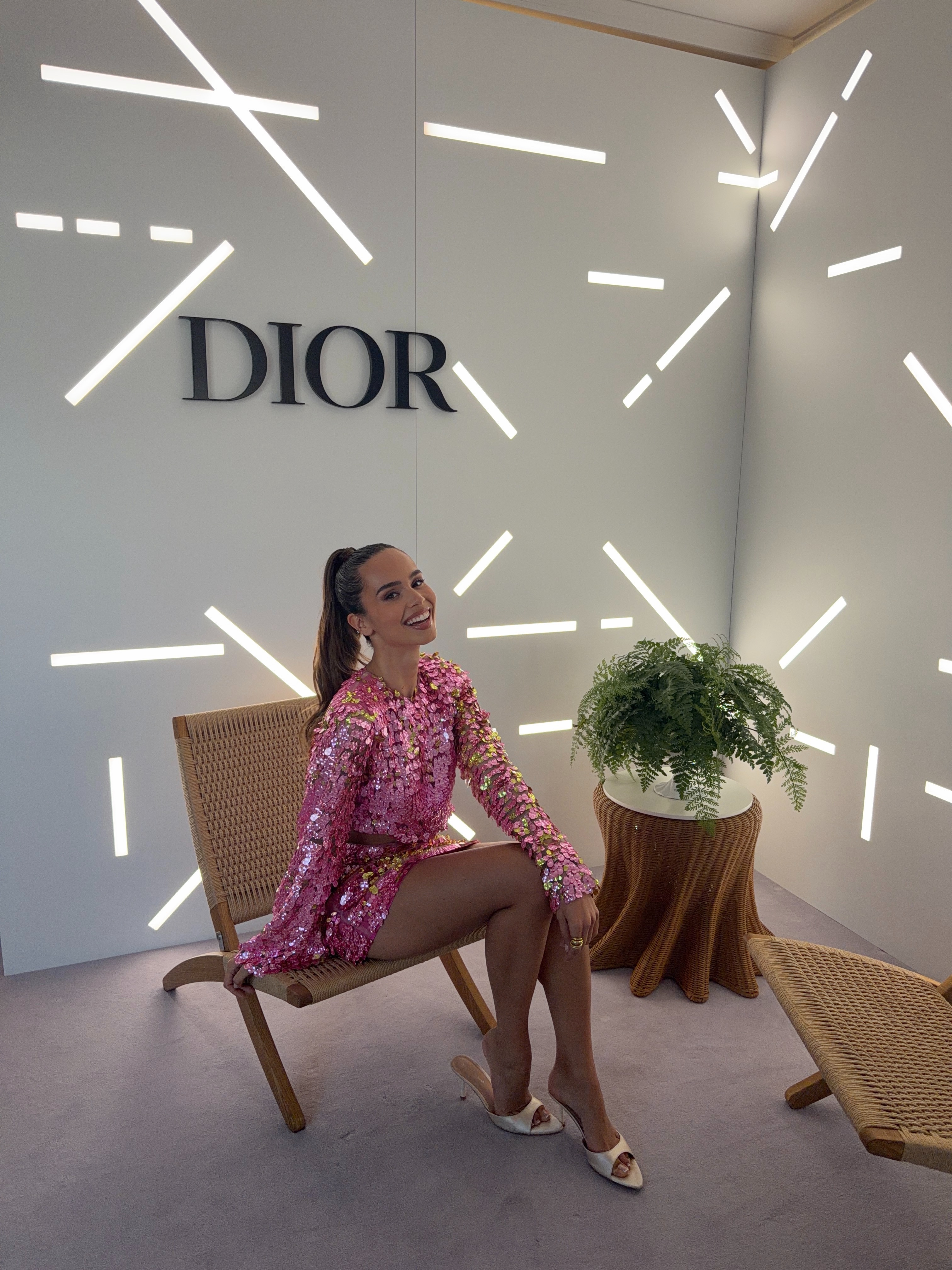 Florence in a pink sequined look seated at a Dior beauty event