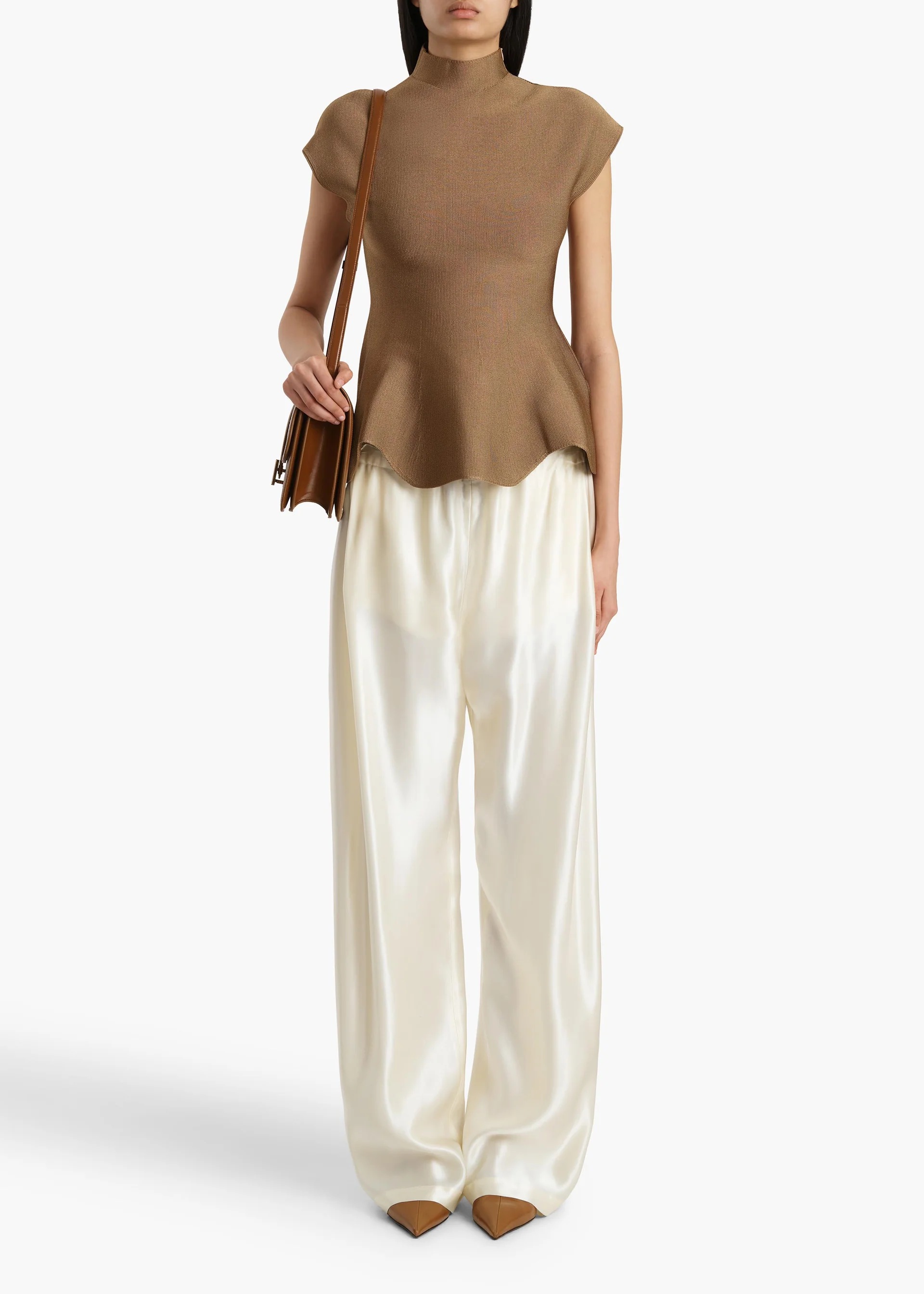 Khaite Andra top in Carob styled with fluid ivory trousers