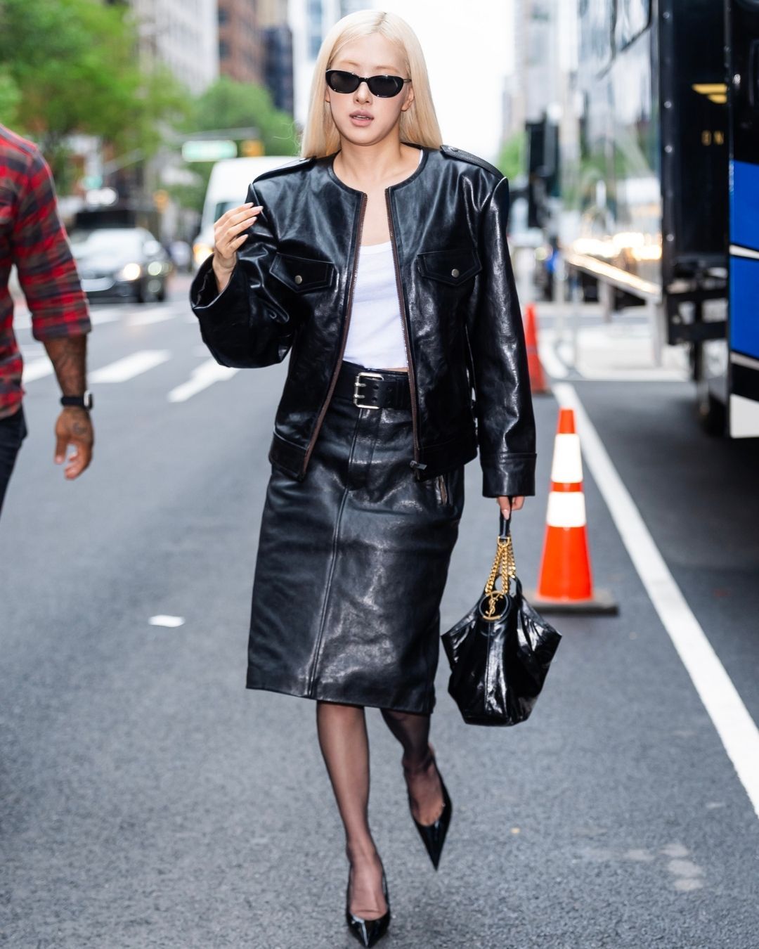 Rosé in a black Saint Laurent leather jacket, pencil skirt, heels, and Hortense Hobo