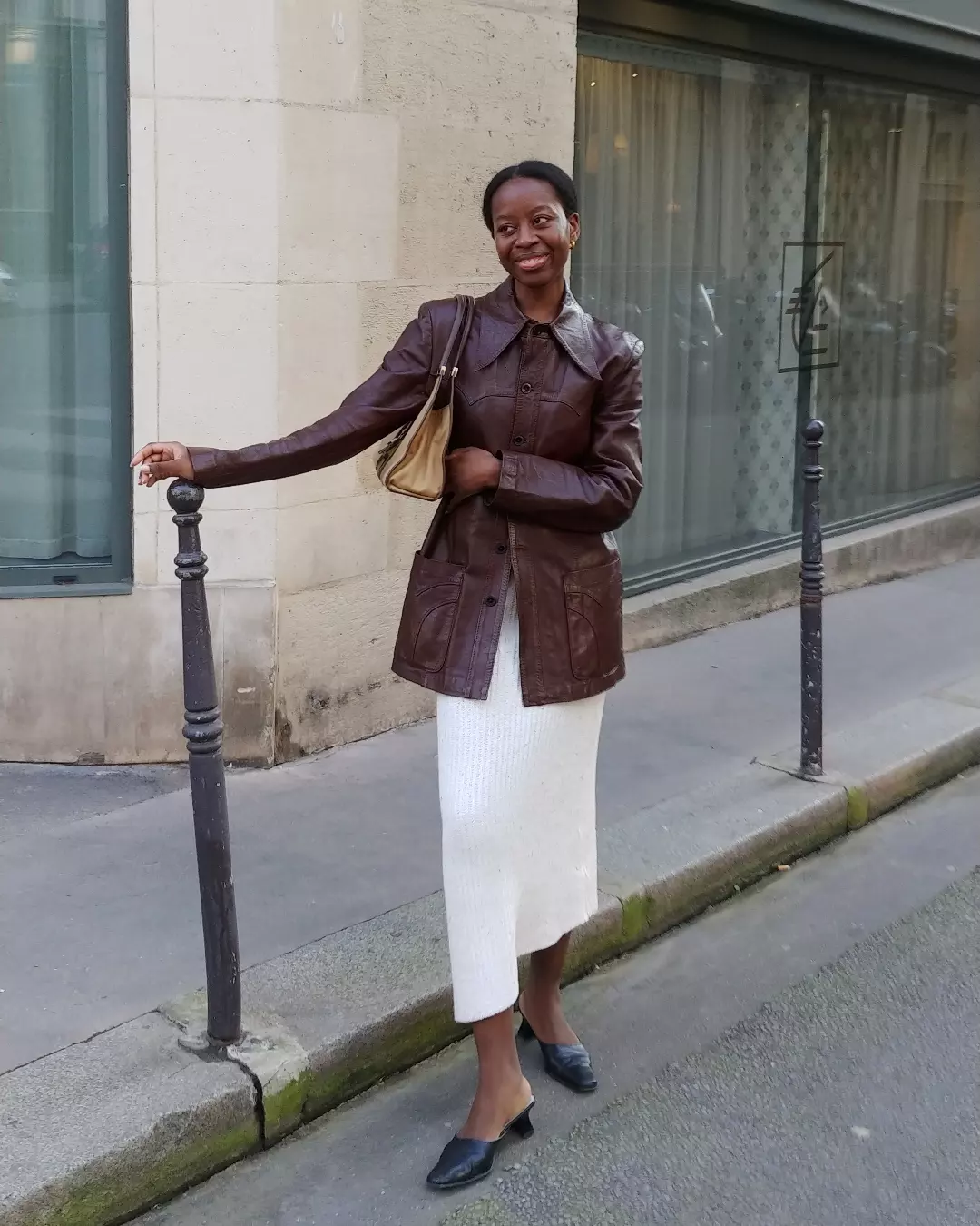 Burgundy leather jacket styled with a cream midi skirt