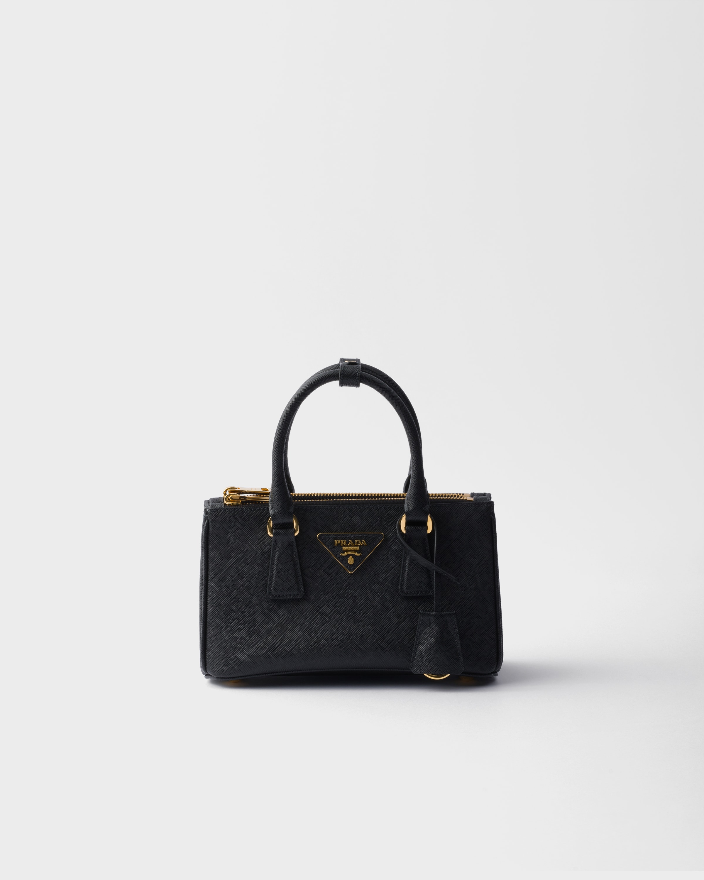 Black Prada Galleria mini Saffiano leather bag front view with leather triangle logo and top handles.
