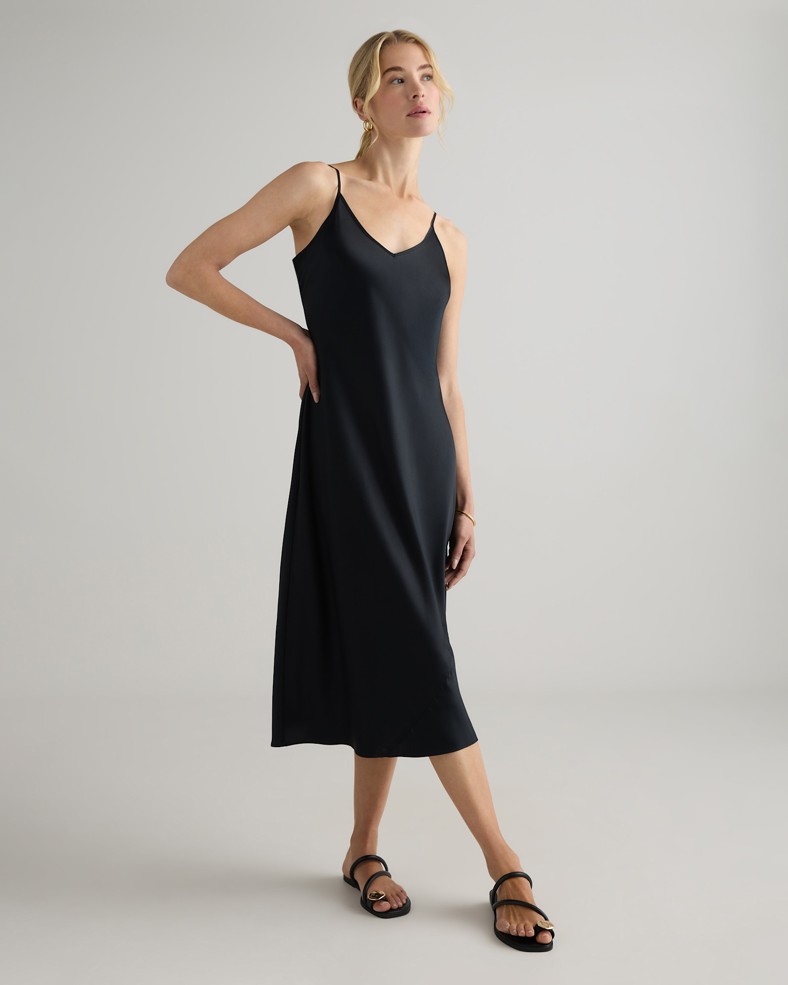 Model wearing the Quince black silk slip dress from the front