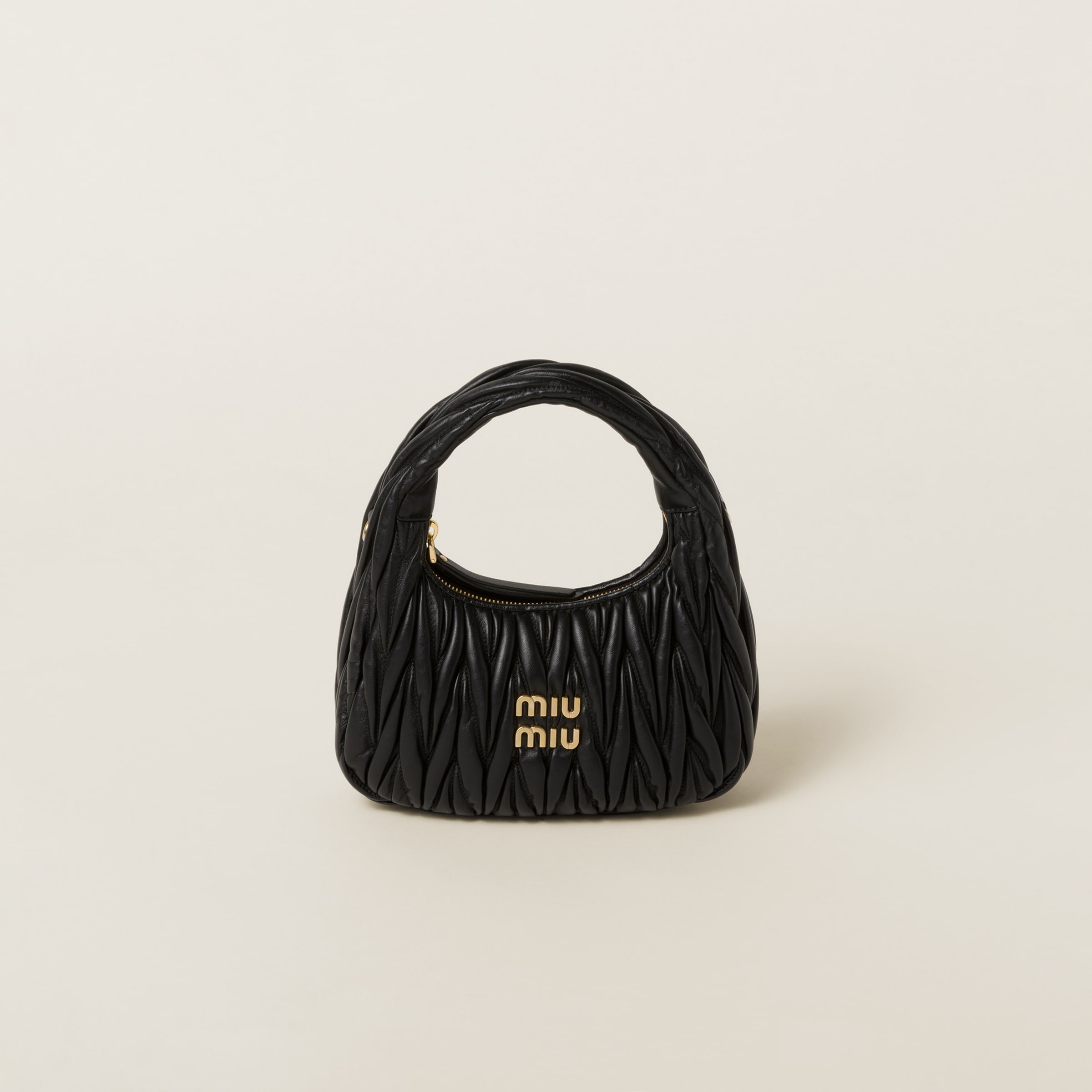 Miu Miu Wander black matelasse nappa leather hobo bag front view with gold metal lettering logo.