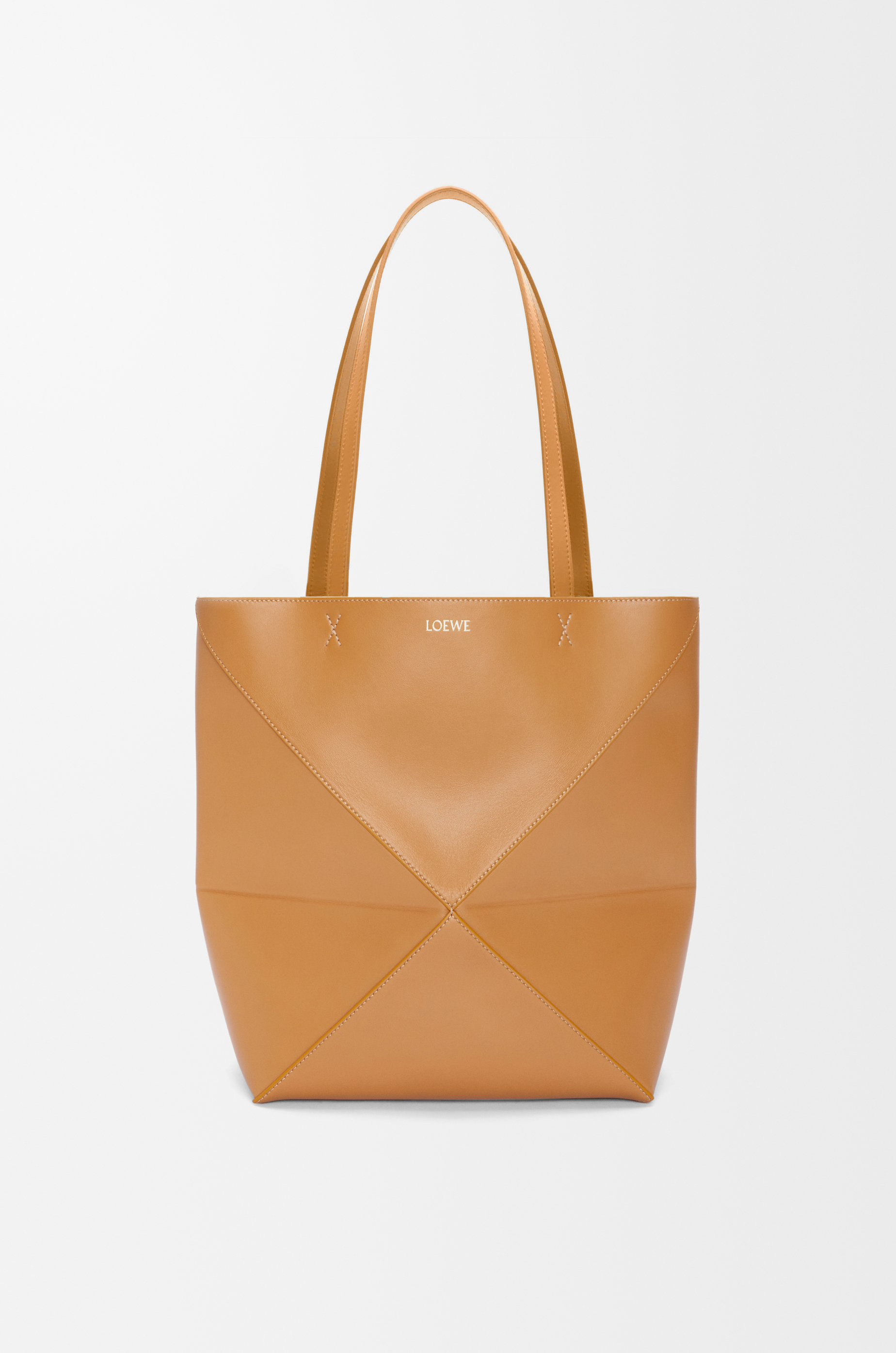 Loewe Medium Puzzle Fold Tote in tan shiny calfskin, front view with folded base and long handles visible