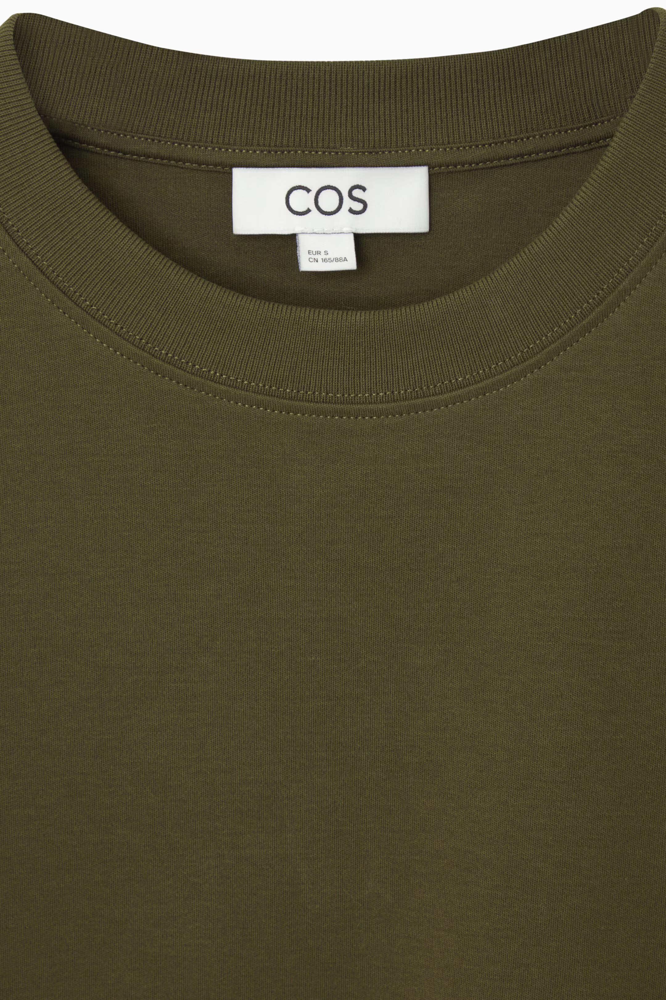 Close view of COS olive Clean Cut T-shirt neckline and cotton jersey