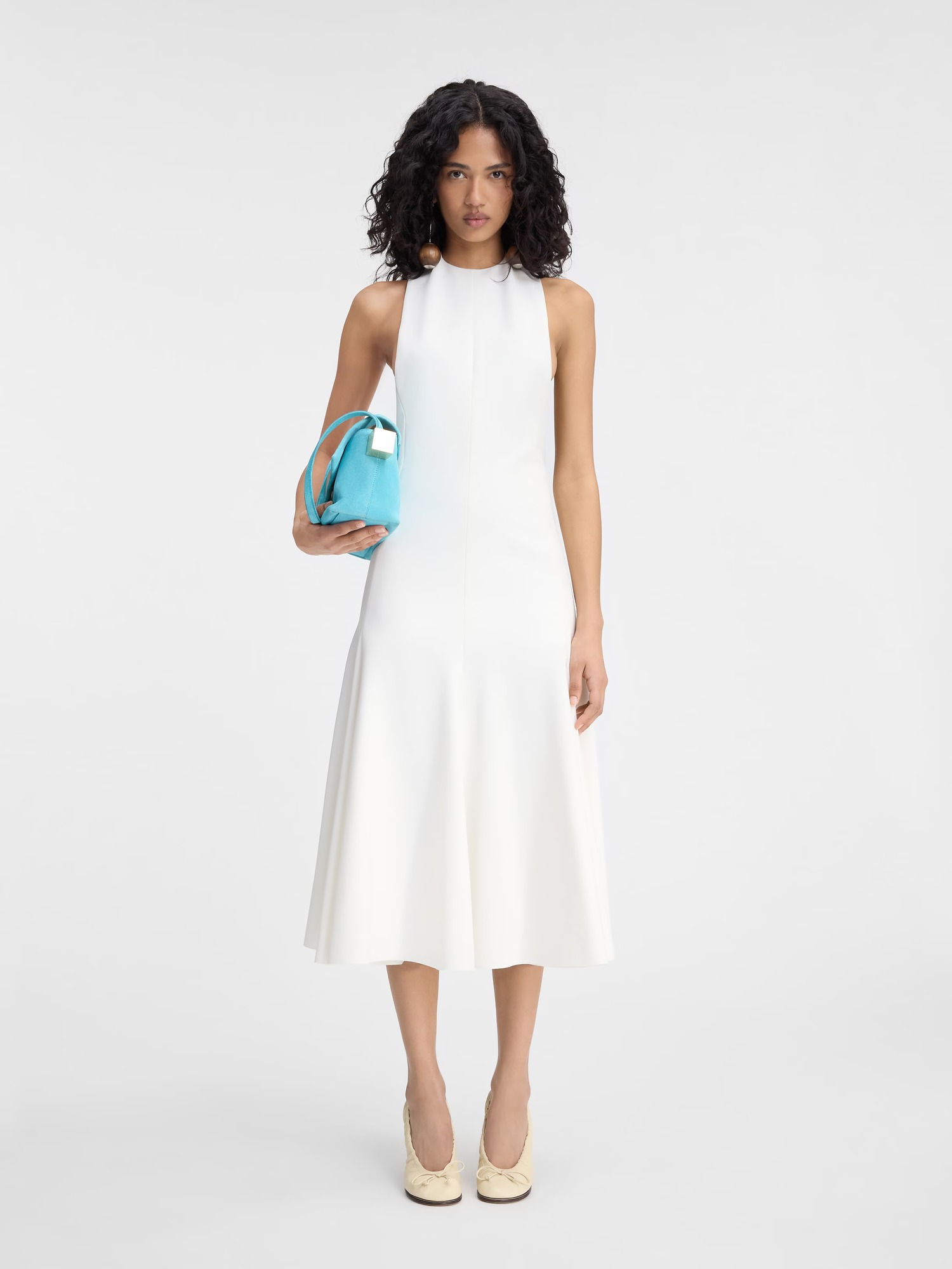 Jacquemus The Favola dress in white, official product image showing the halter neckline and mid-calf length