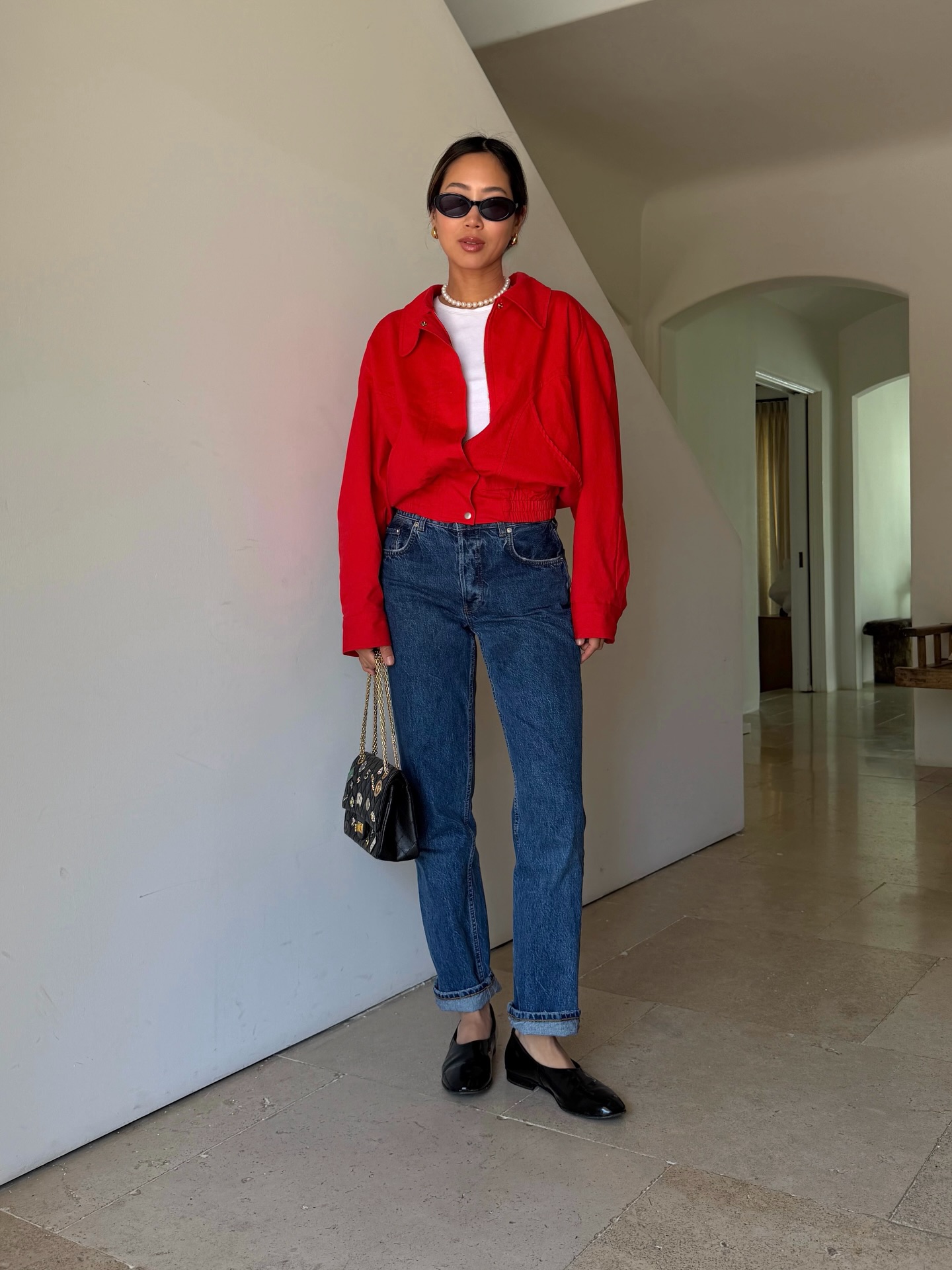 Miu Miu loafers styled with denim and a red shirt in a full-length outfit photo