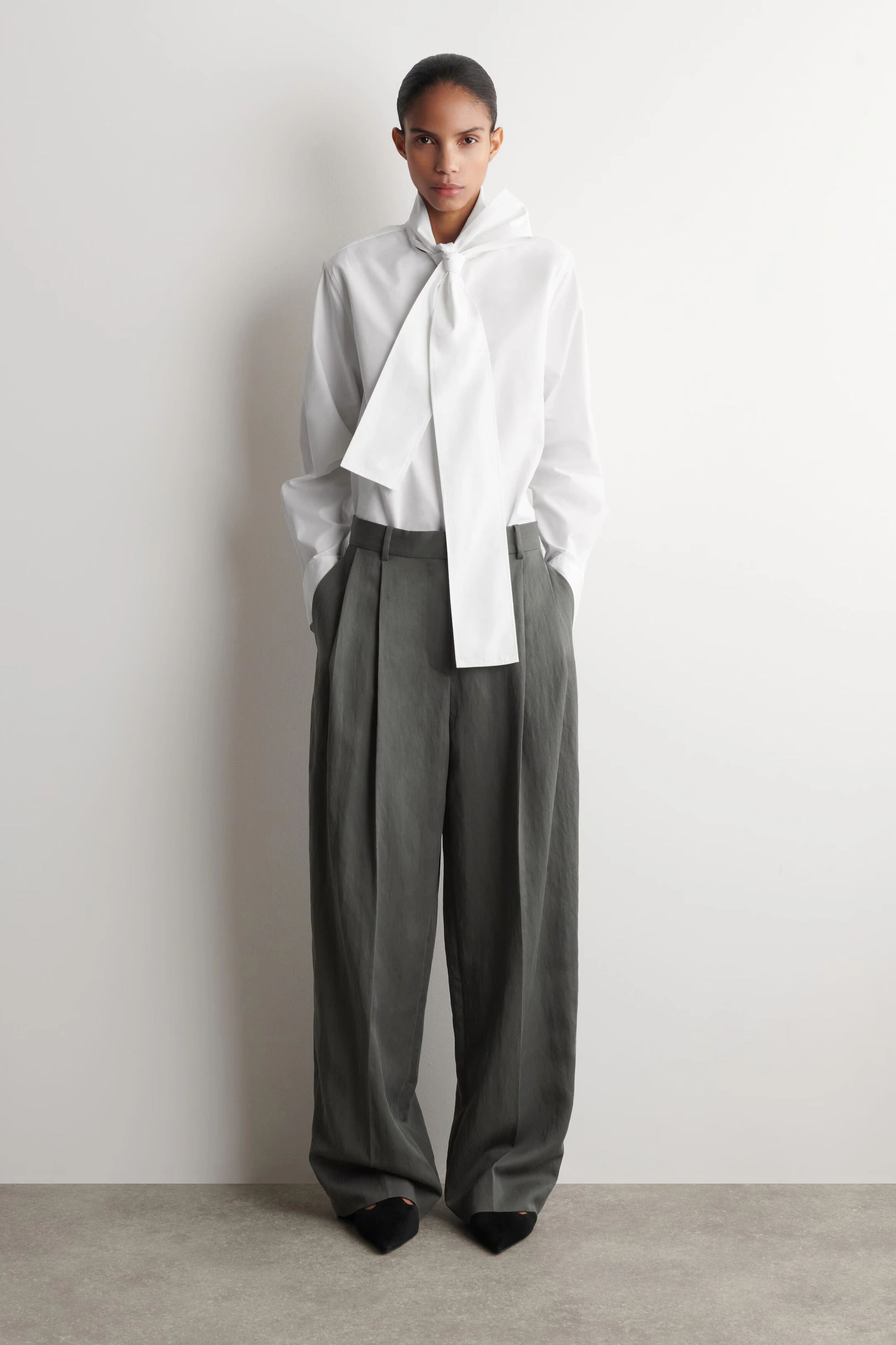 COS Relaxed Fluid Wide-Leg Pants in Dark Gray, shown full length on model