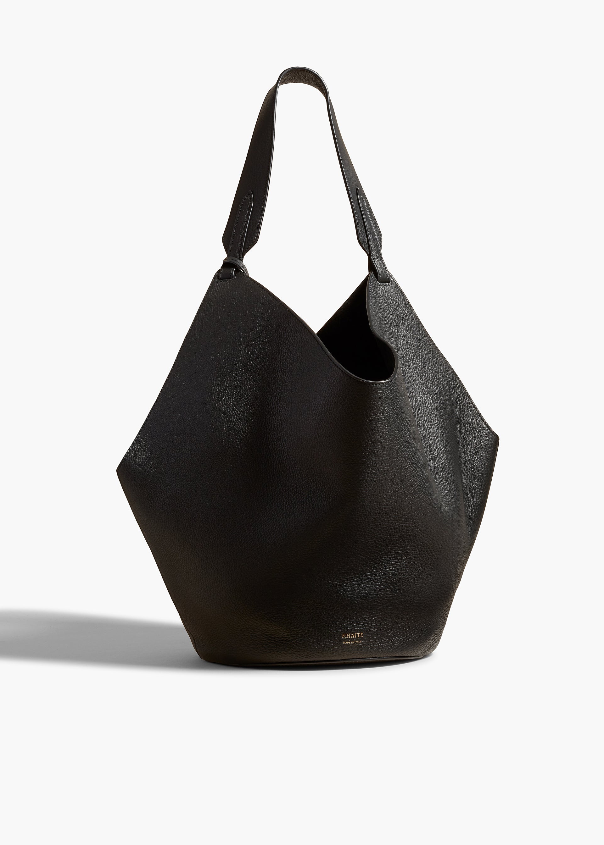 Khaite Medium Lotus Tote in Black Pebbled Leather, front product view with soft scarf-inspired shape.