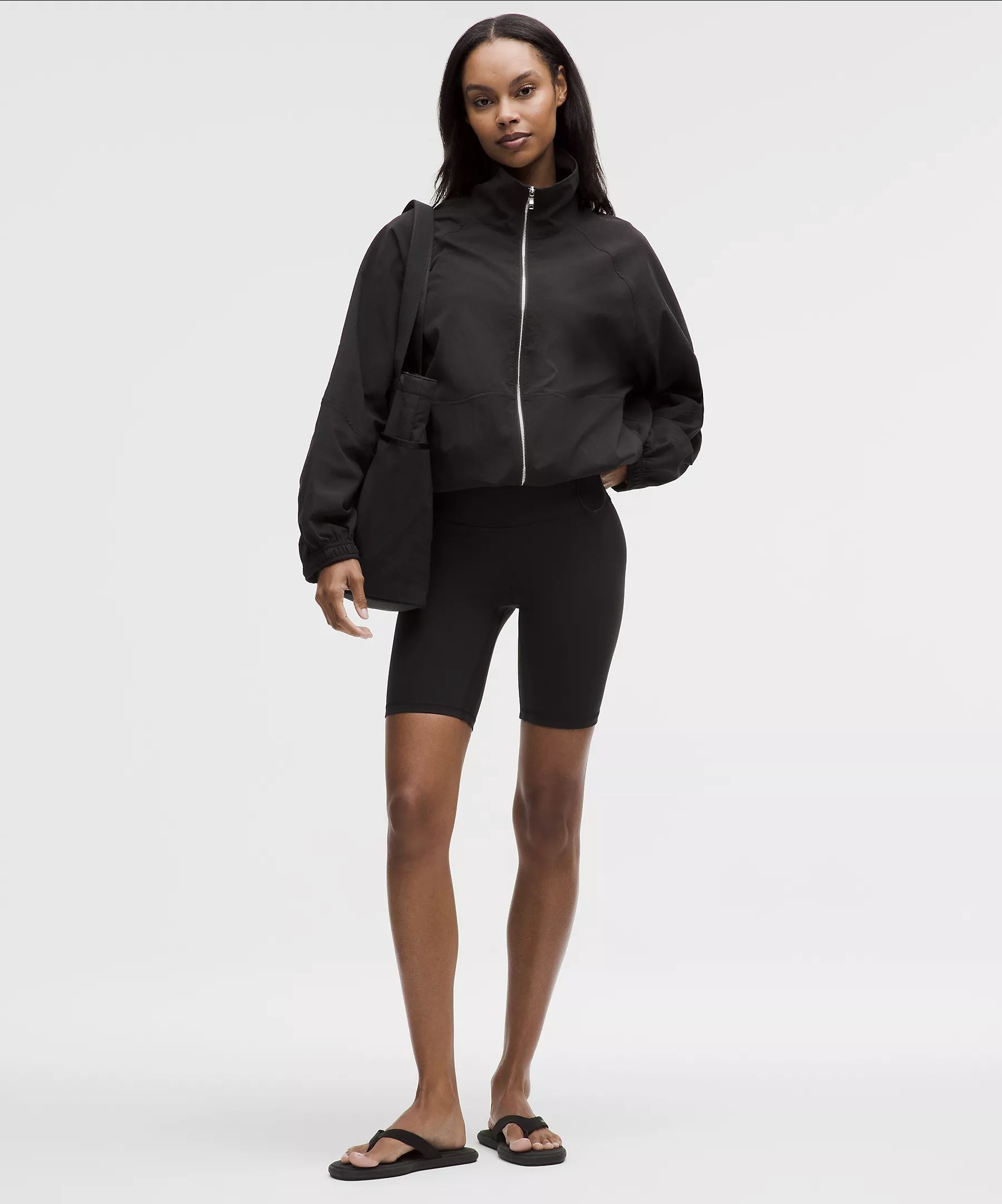 Model wearing the black lululemon Ultralight WovenAir Jacket
