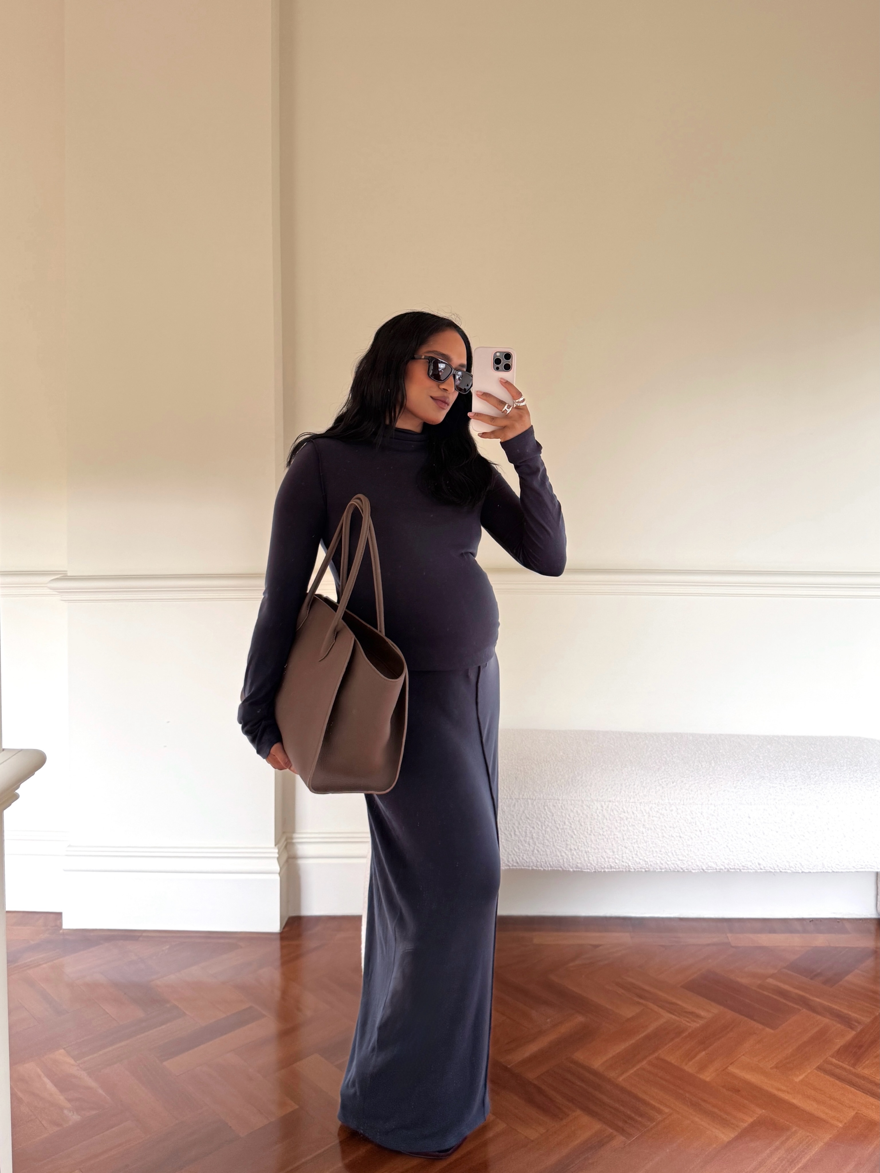 Tan Prada shoulder bag worn with a long dark dress in a mirror outfit photo