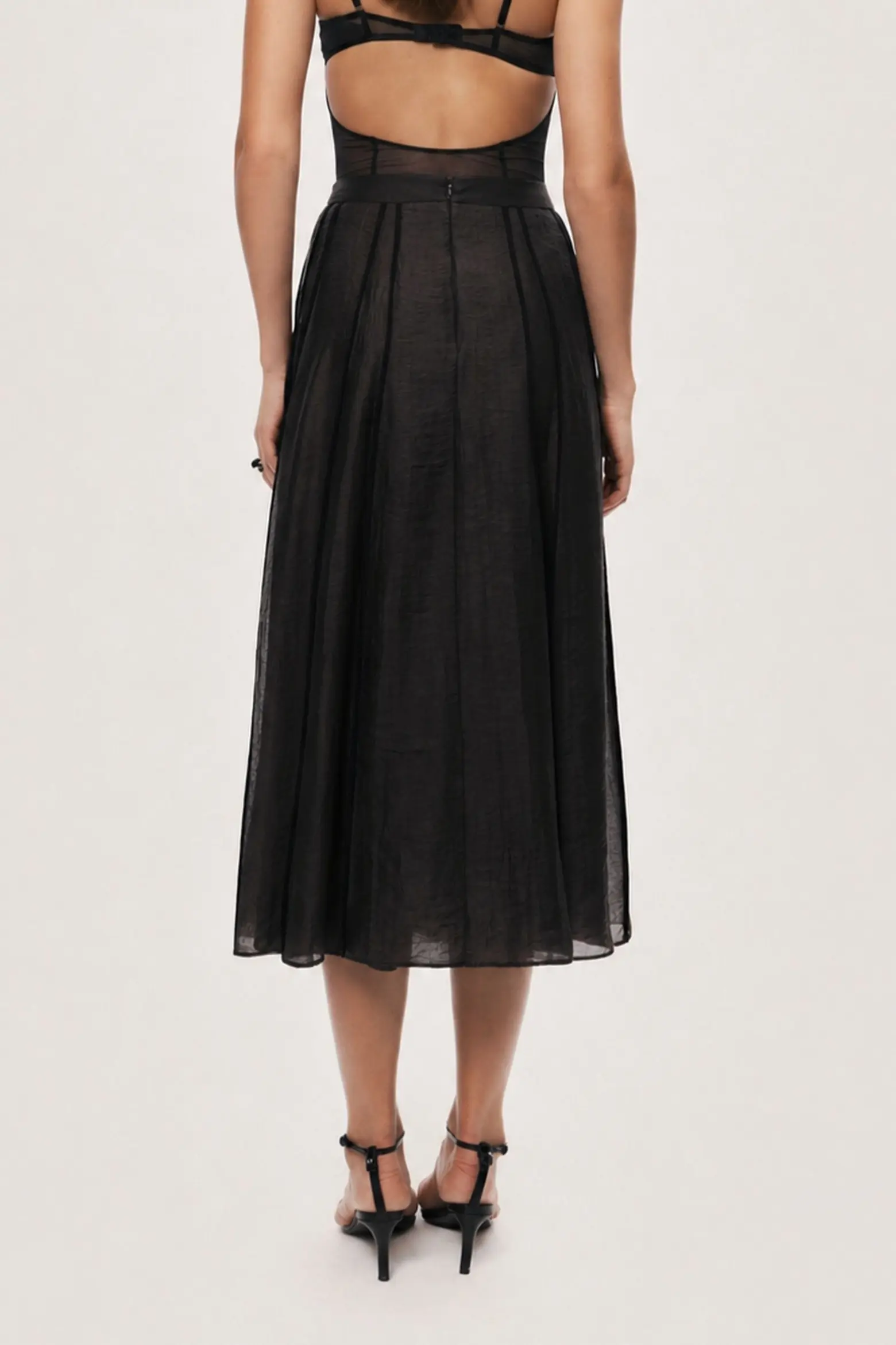 Nocturne black sheer pleated midi skirt shown from the back