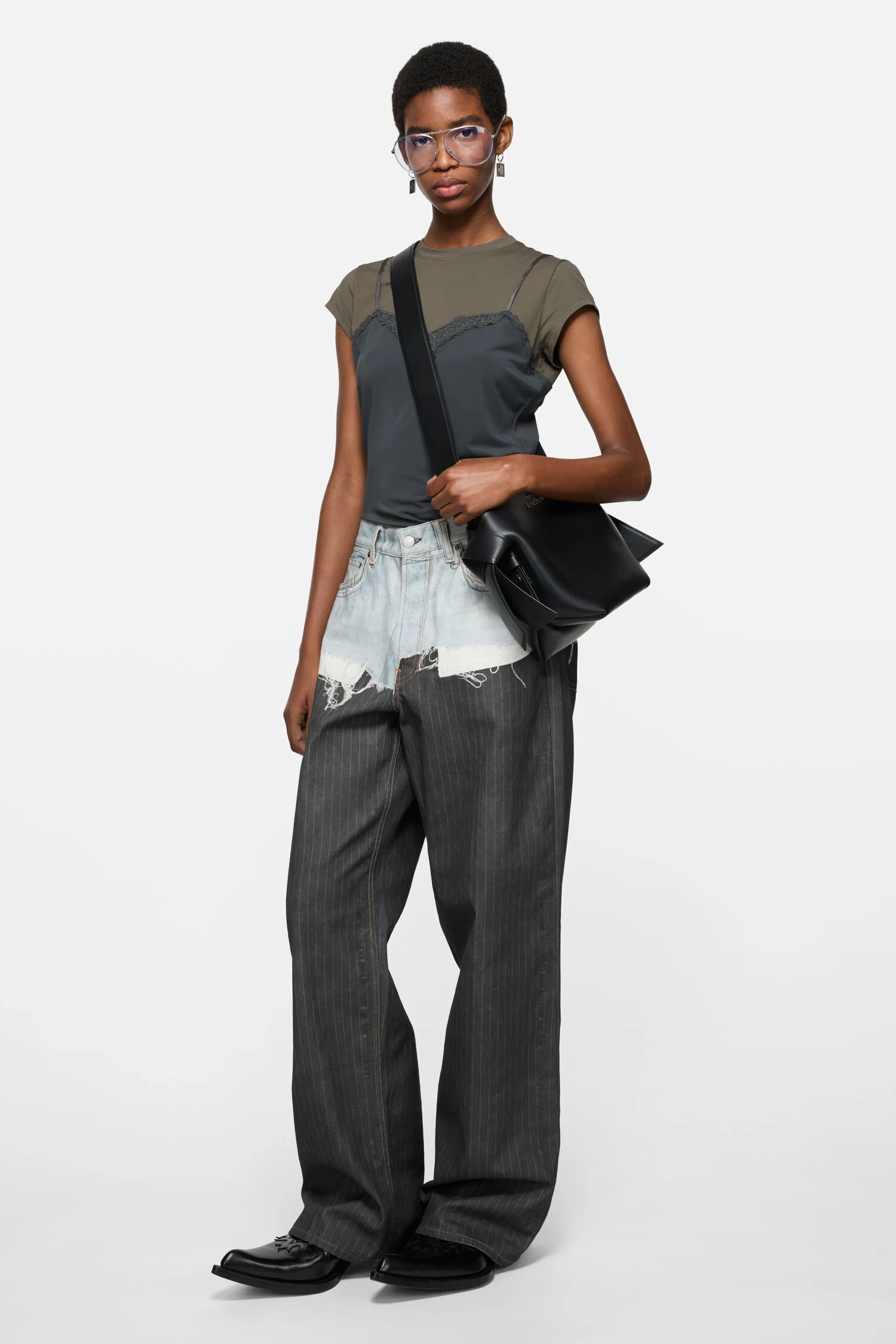 Model wearing the black Acne Studios Musubi Mini R crossbody bag