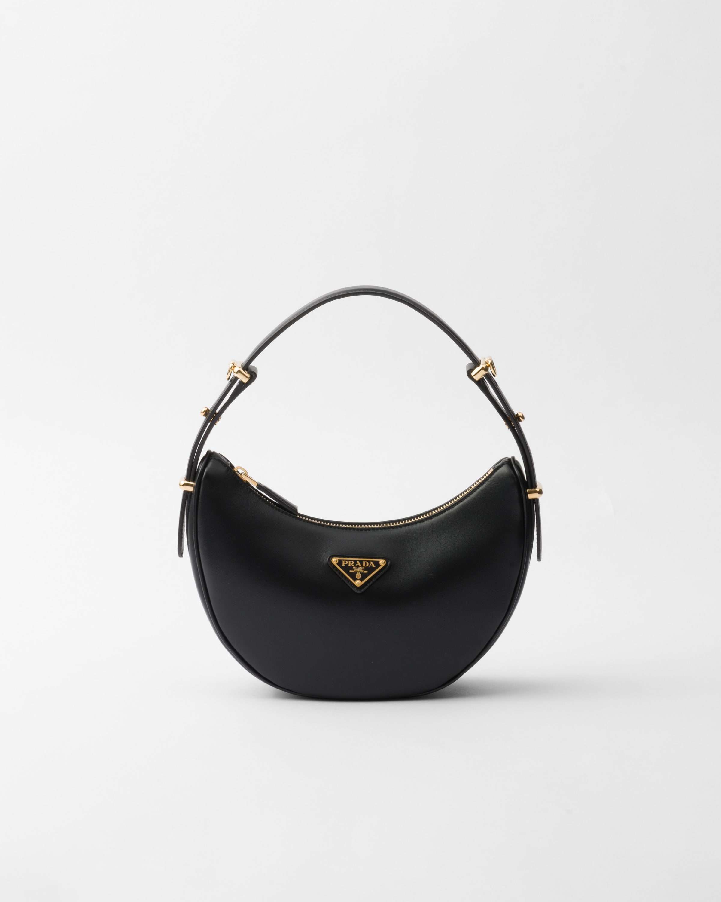 Black Prada Arqué small leather shoulder bag front view with curved body and triangle logo.