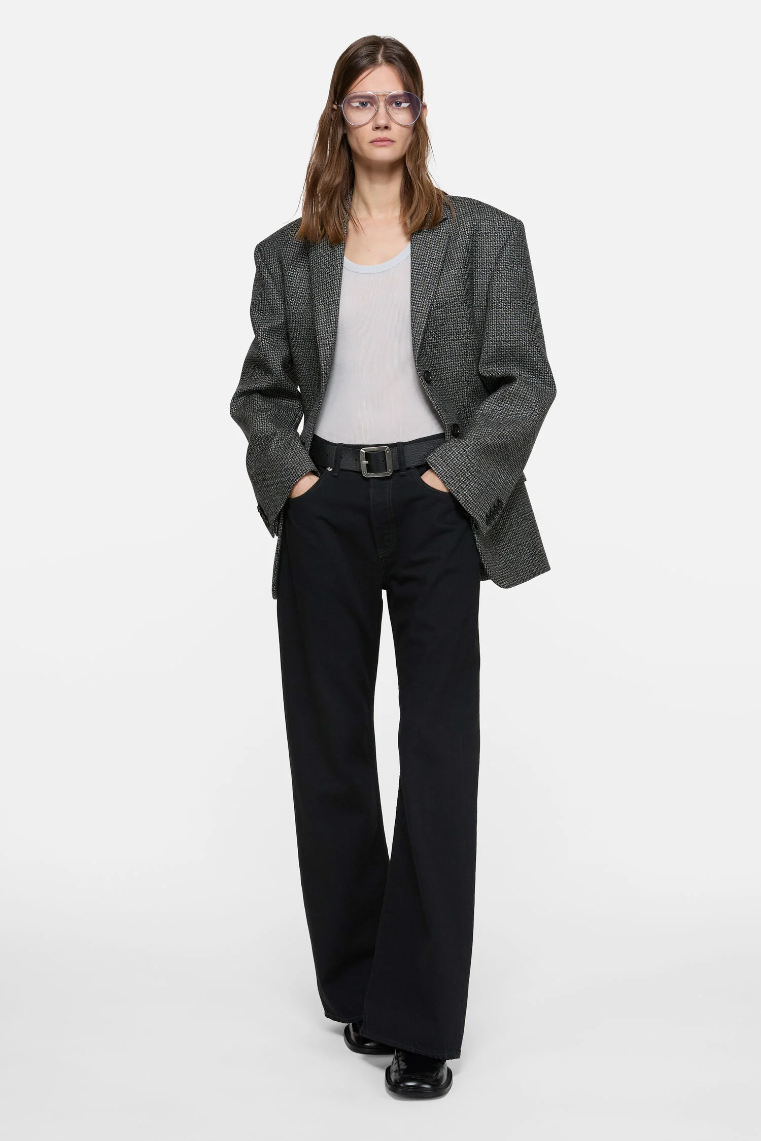 Model wearing black Acne Studios 2021F jeans with a long straight fit