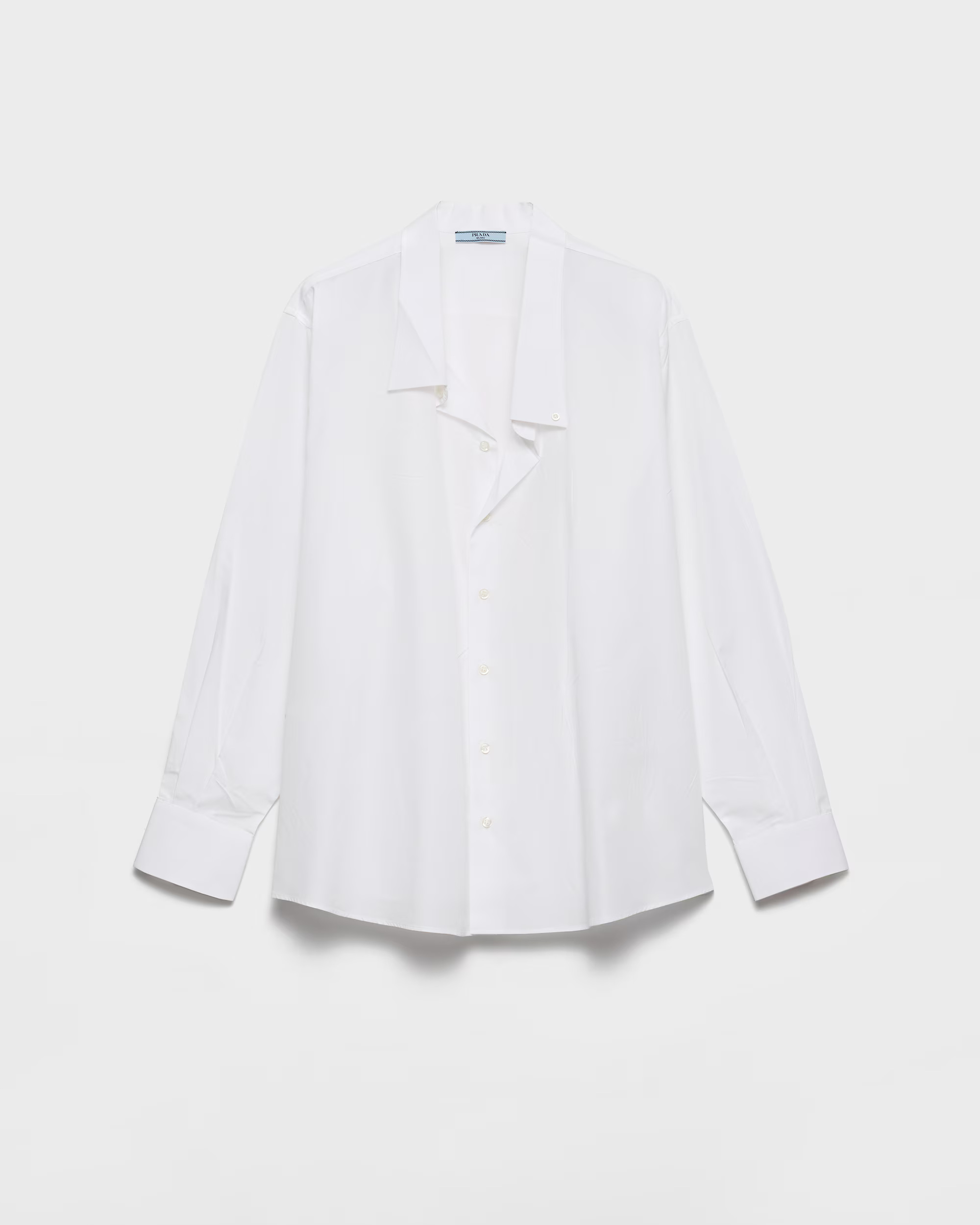 White Prada poplin shirt with a pointed collar and long sleeves