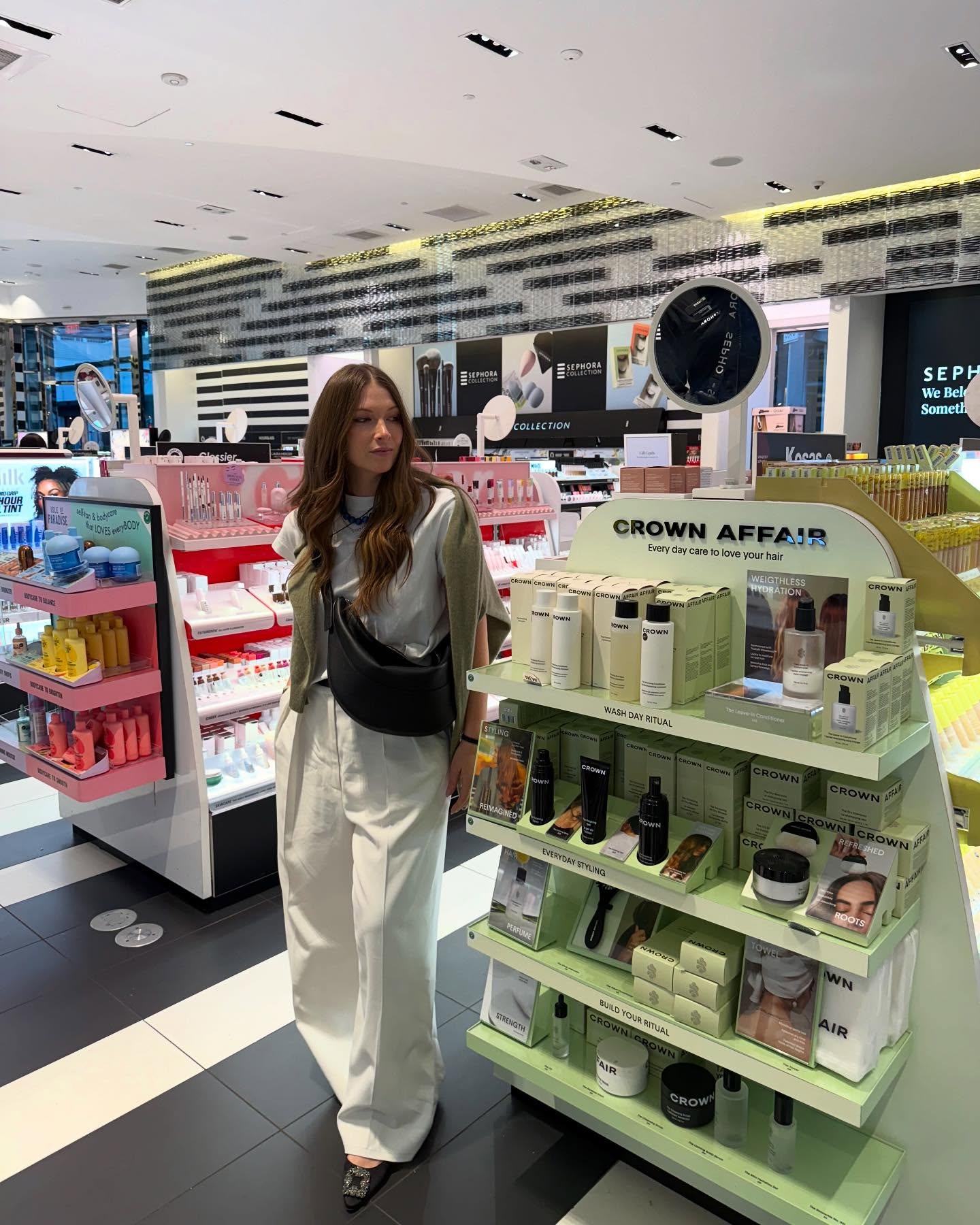 Creator @diannacohen standing head to toe beside a hair-care display inside Sephora during a Savings Event shopping trip